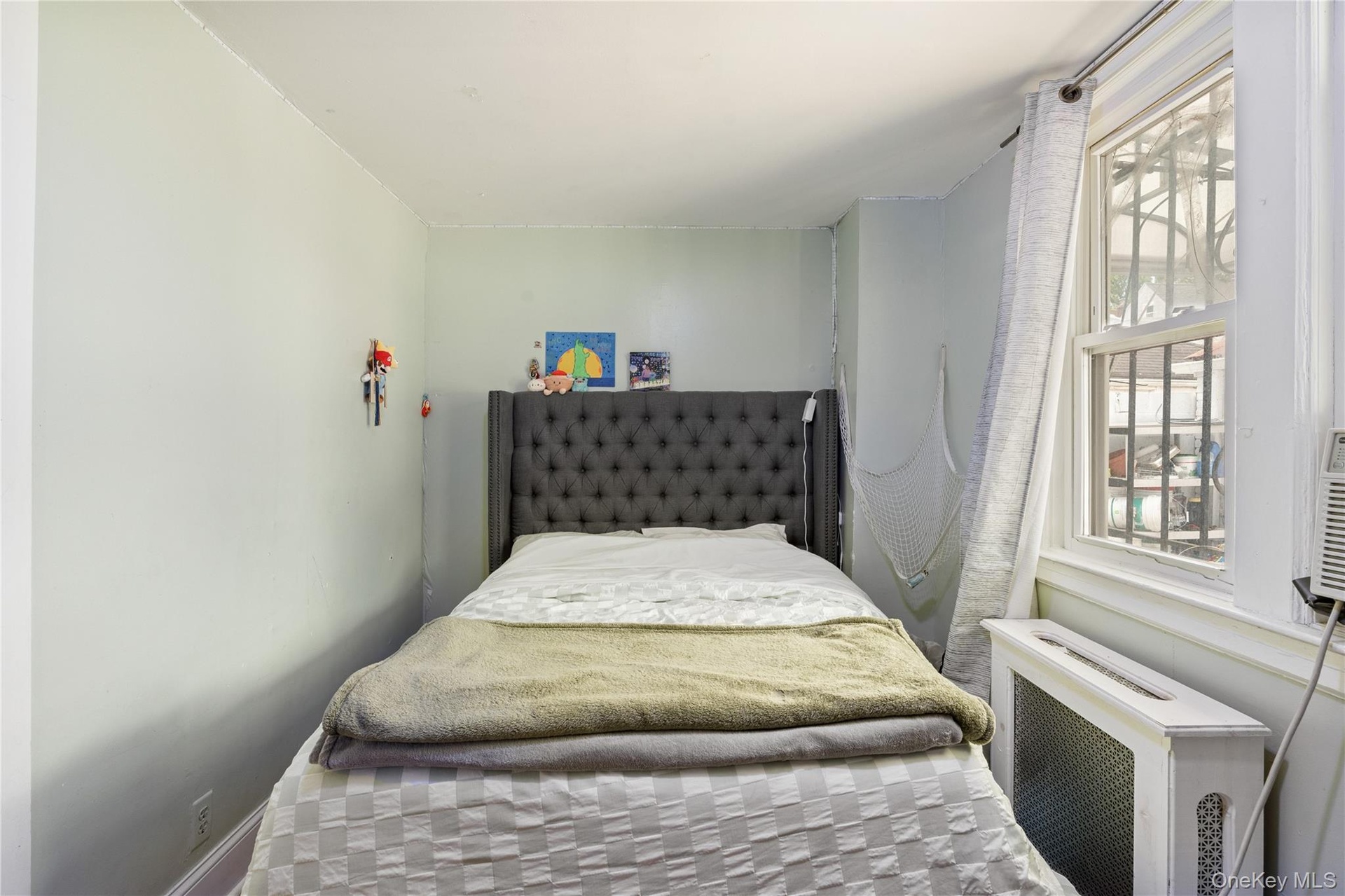 Bright bedroom featuring ample natural light, a large window, and comfortable living space. 1st Floor.