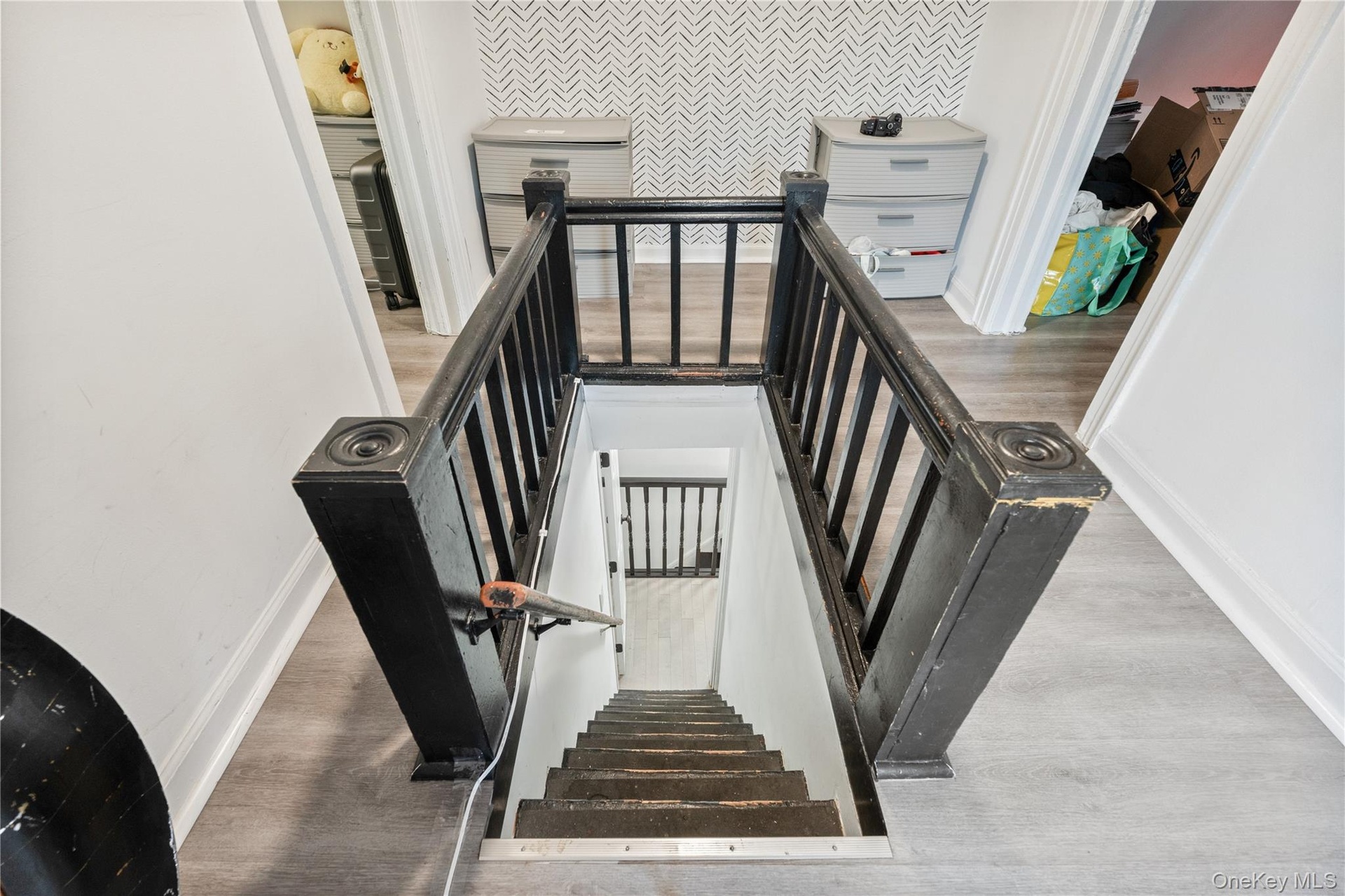 Upper-level hallway featuring updated flooring, distinctive architectural details, and access to multiple rooms. 2nd Floor Unit.