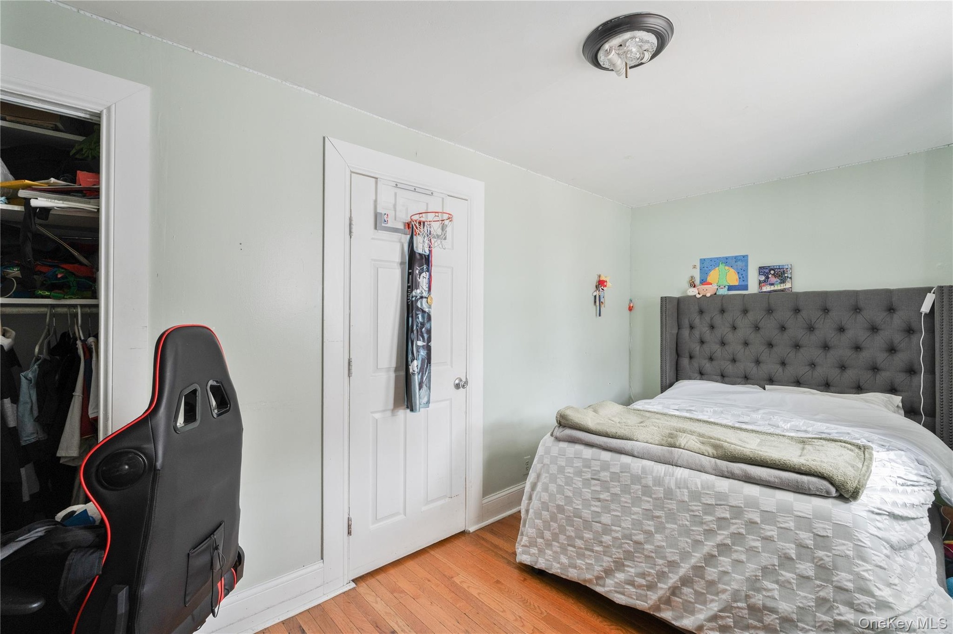 Spacious bedroom featuring hardwood floors, generous closet space, and plenty of room for comfortable living.