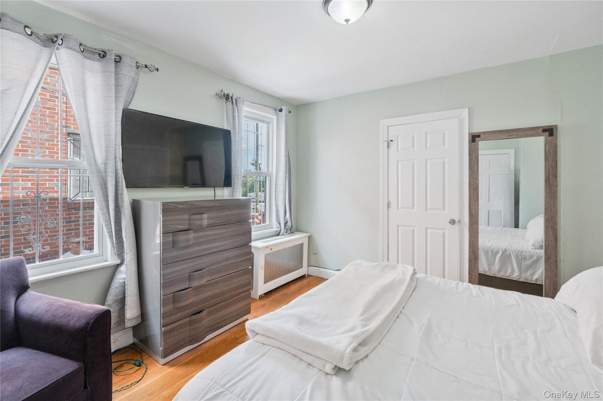 Wood-finish flooring with a flush-mounted ceiling light fixture. 1st Floor.