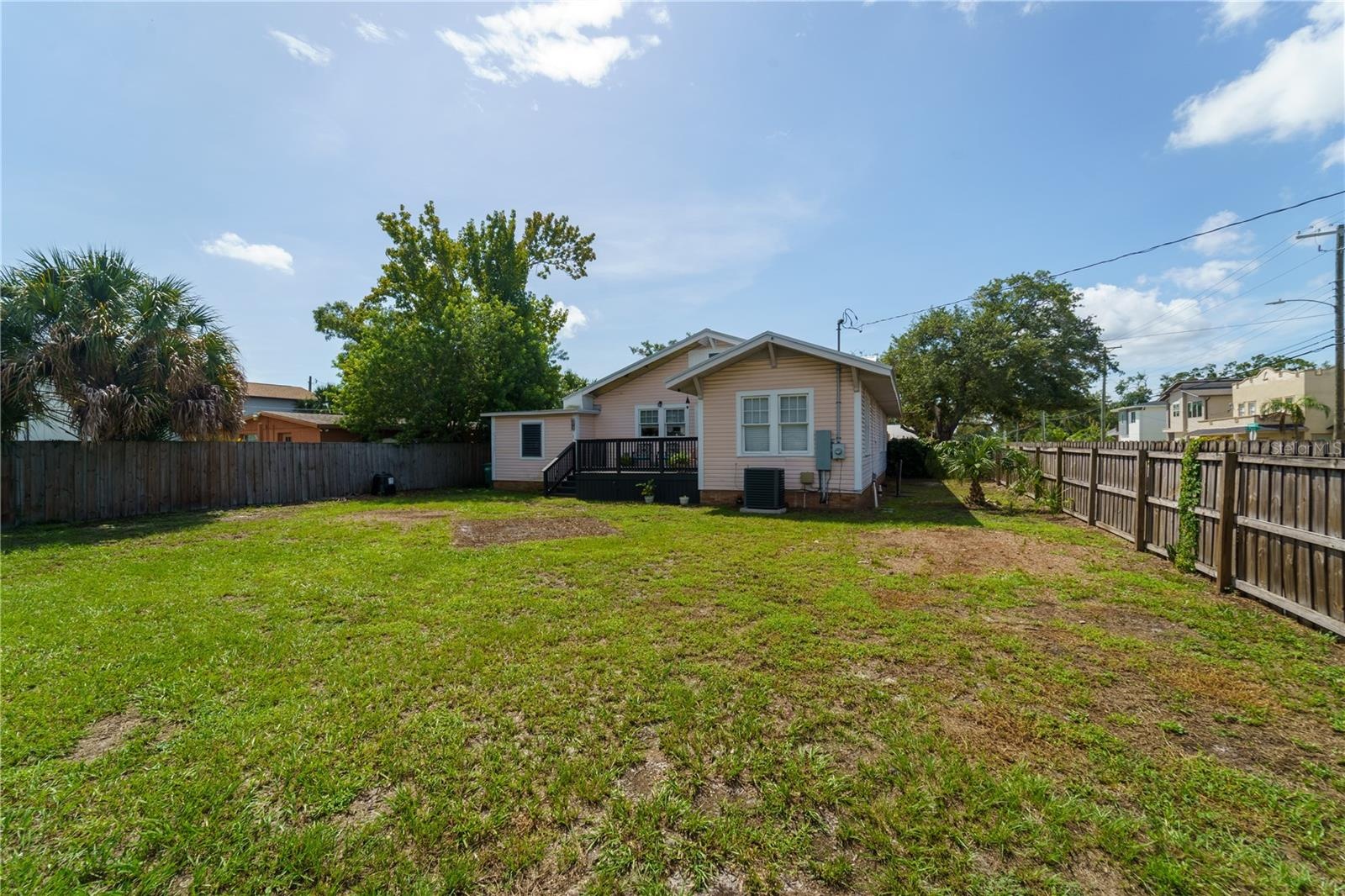 The backyard is enormous - and a blank slate. The alley sits behind the fence at the rear of the property. You could easily add a garage with an ADU, 