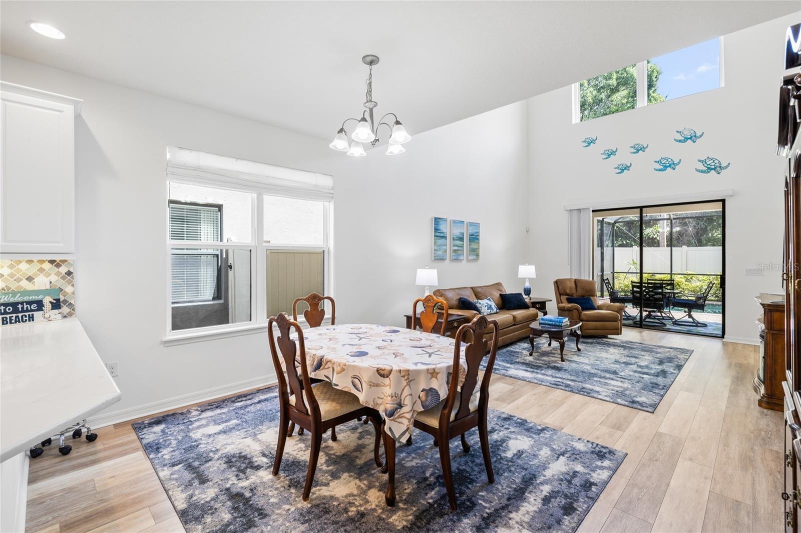 Dining area looking into Great Room with 20' ceilings, and over looking pool.