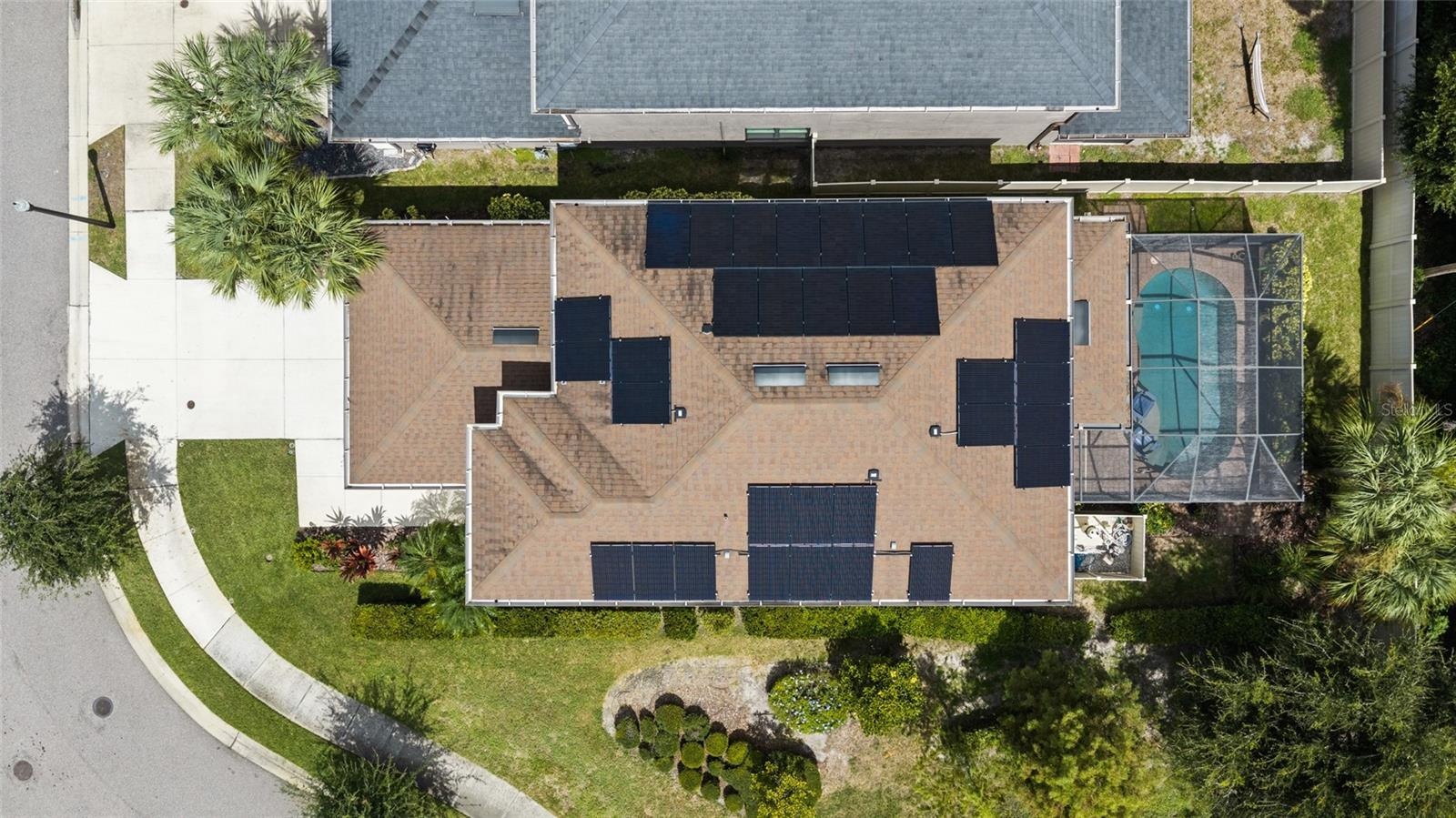 Aerial view - all solar panels are owned. Open space to the side of the house - so only one neighbor.