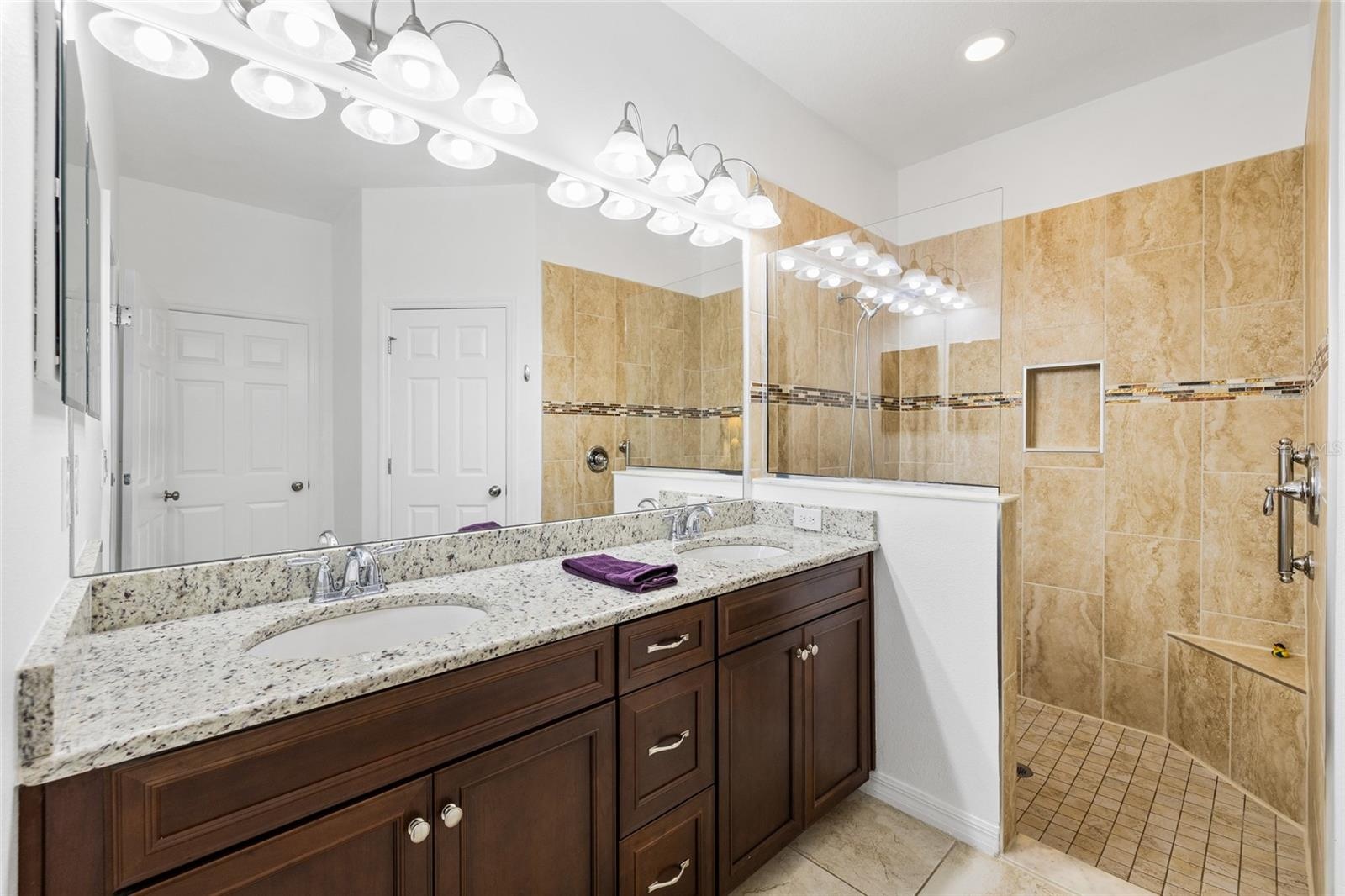 Primary bathroom - tall counters, double sink, wlak in shower, walk in closet and private commode room.