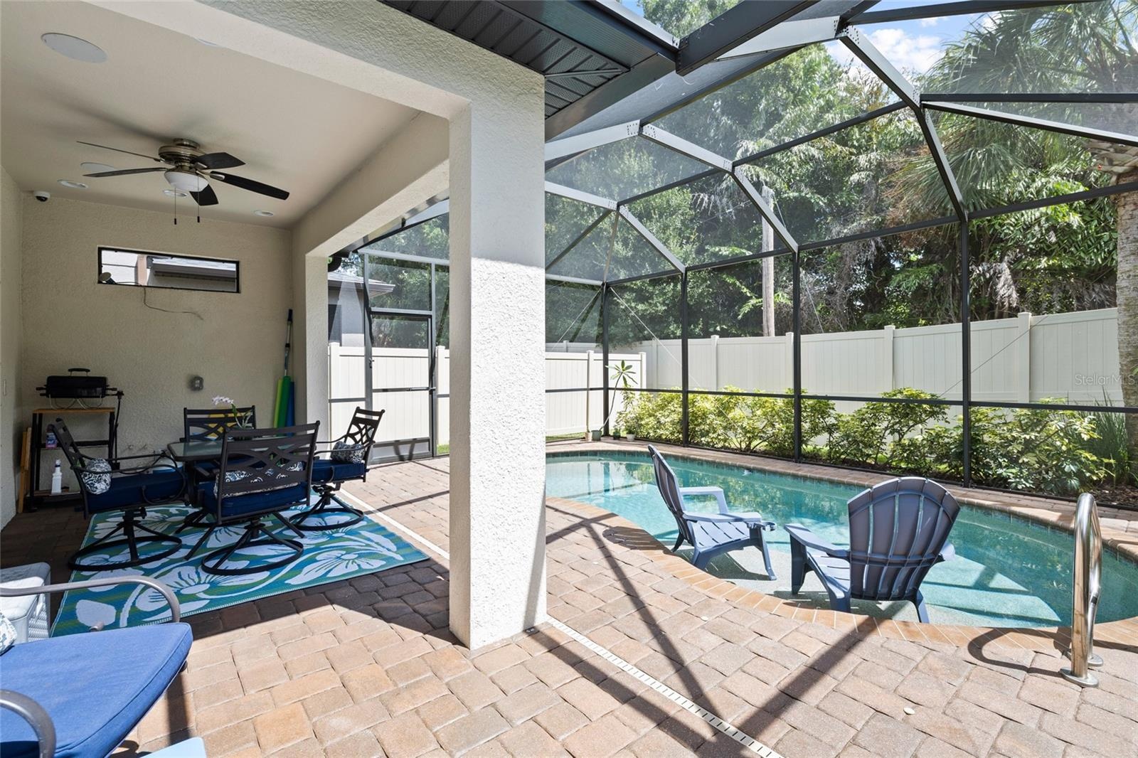 Pool area - salt water pool with "sunning bench". (Chairs are actually on the sunning bench so you can sit with your feet in the water.