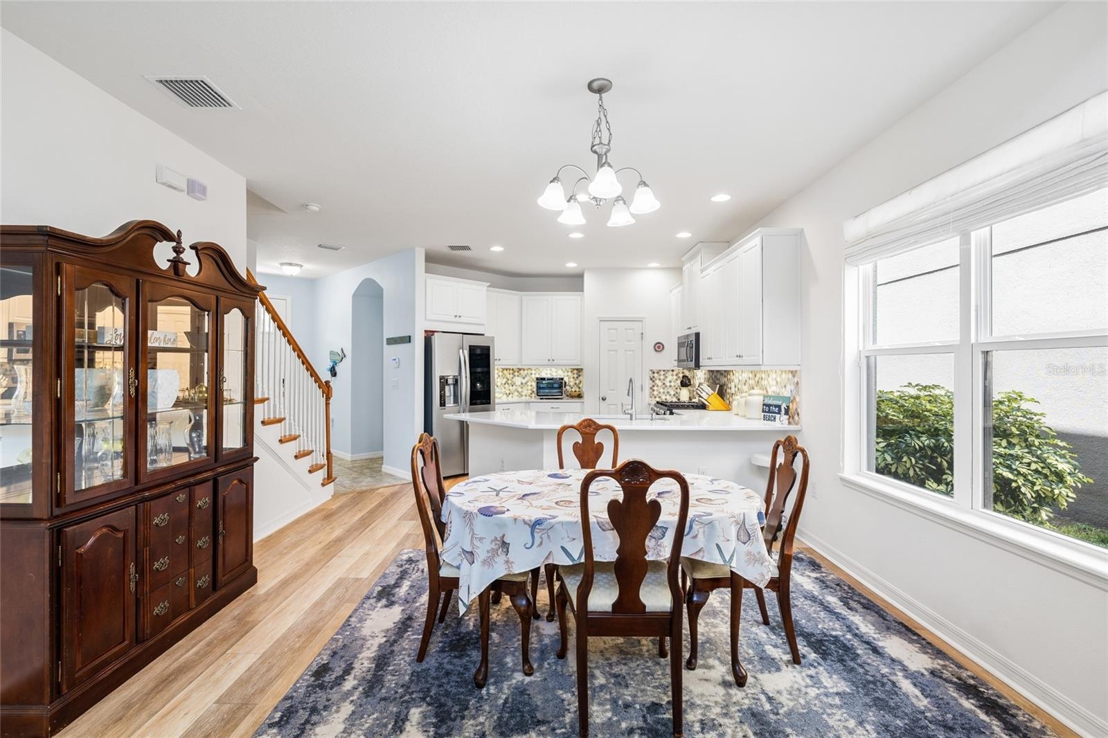 Dining area looking toward kitchen, entry way and garage (arched doorway)