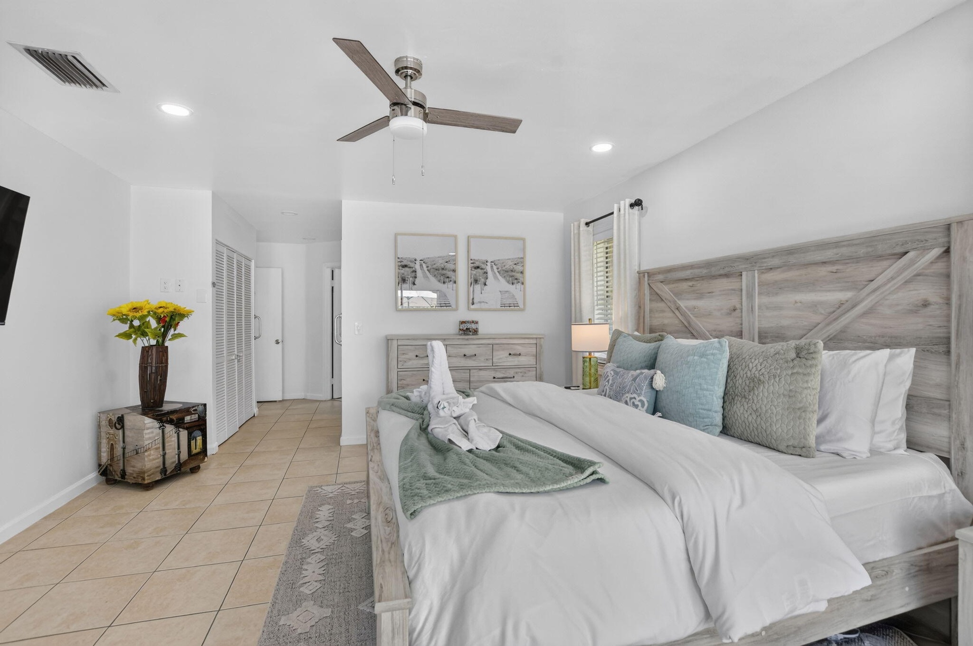 Neutral-toned tile flooring, recessed lighting, and a ceiling fan create a comfortable atmosphere