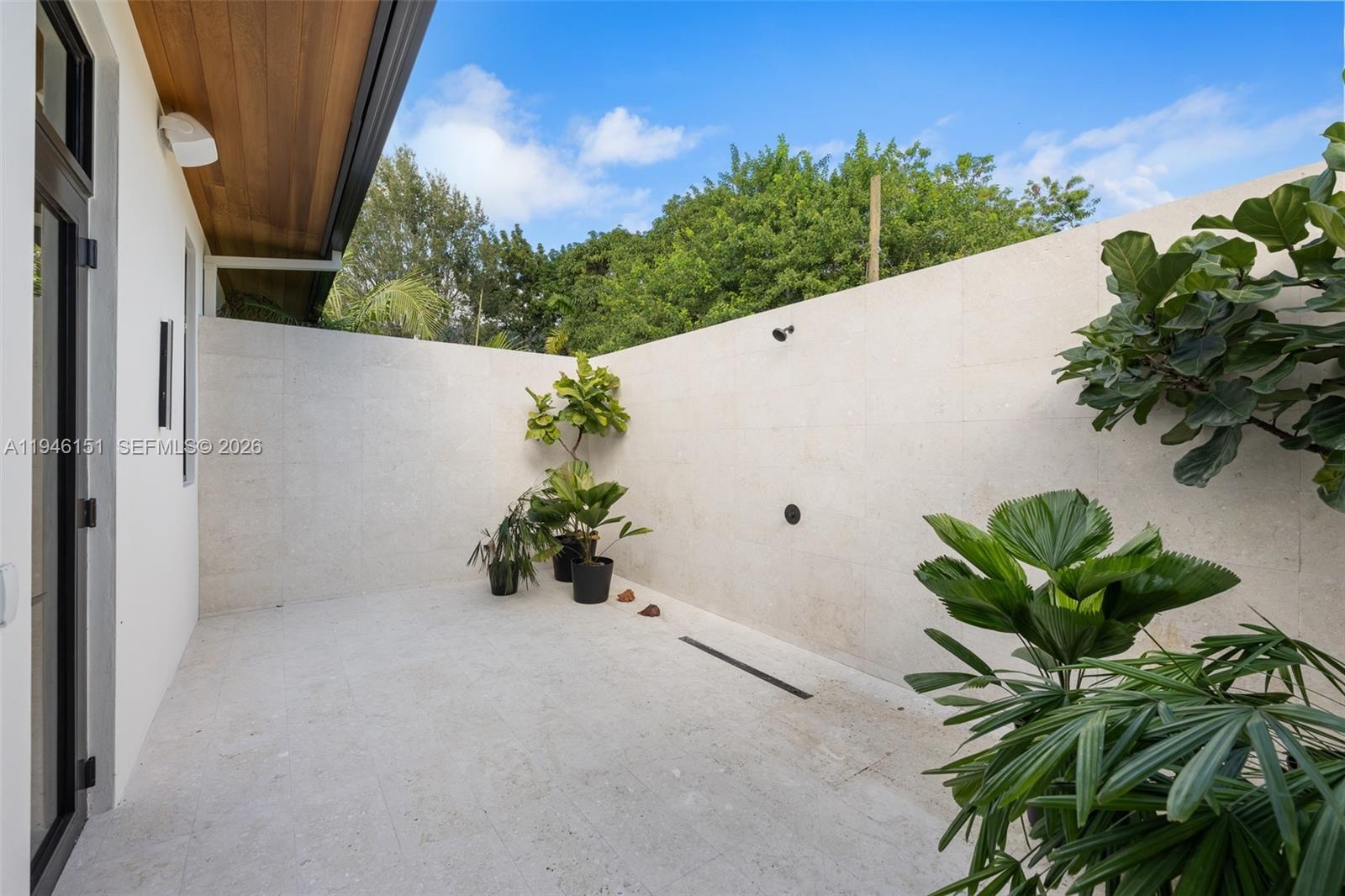 Exterior Shower & Tanning Area with Privacy Wall located in Primary Bedroom