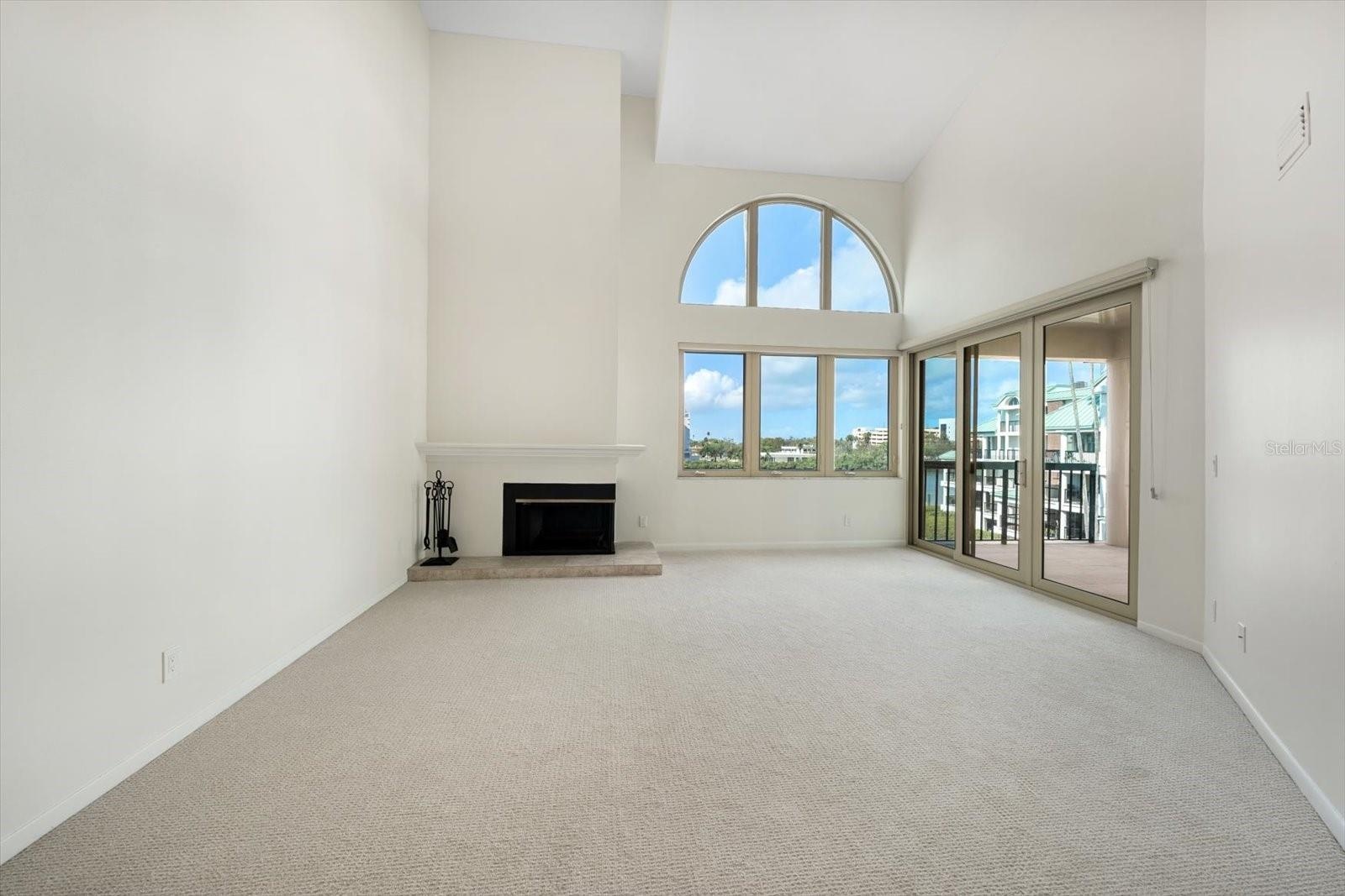 Spacious living room with soaring ceilings and fabulous natural light. Facing west, perfect for enjoying sunsets over the water.
