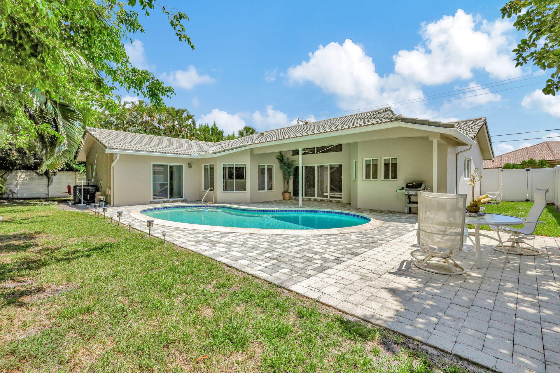 Large fenced-in backyard with a pool