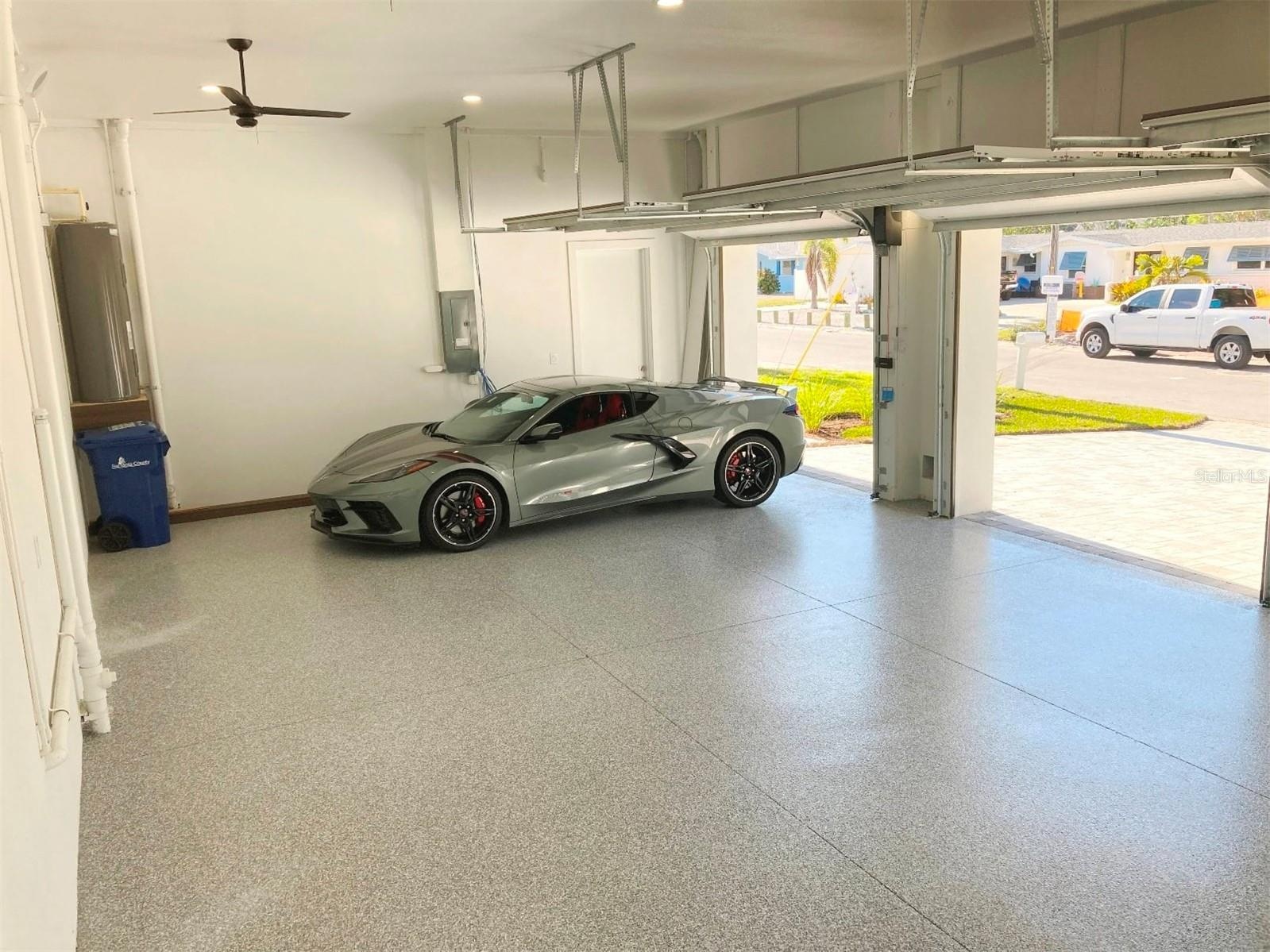Garage has polyaspartic floor, 12 foot ceiling; fans; music speakers; insulated doors