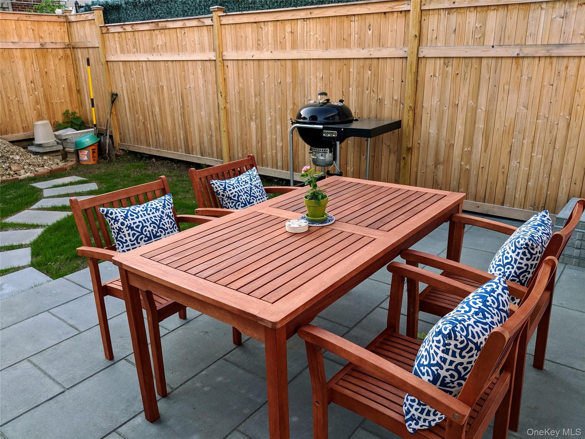 Backyard with bluestone pavers and grassy area