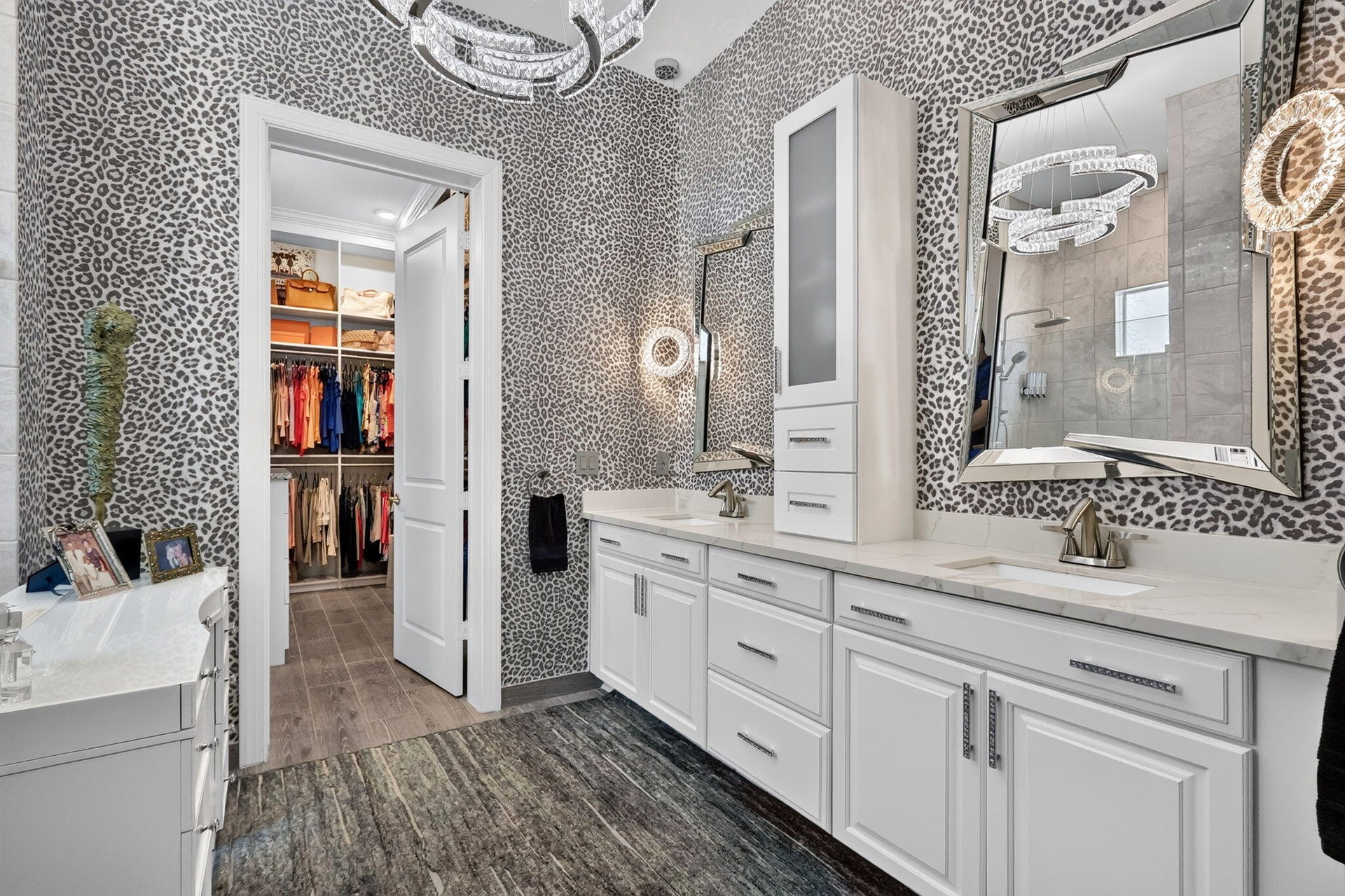 Primary Bathroom with Italian wallpaper, chandelier, double vanity with lots of storage. Also additional linen closet