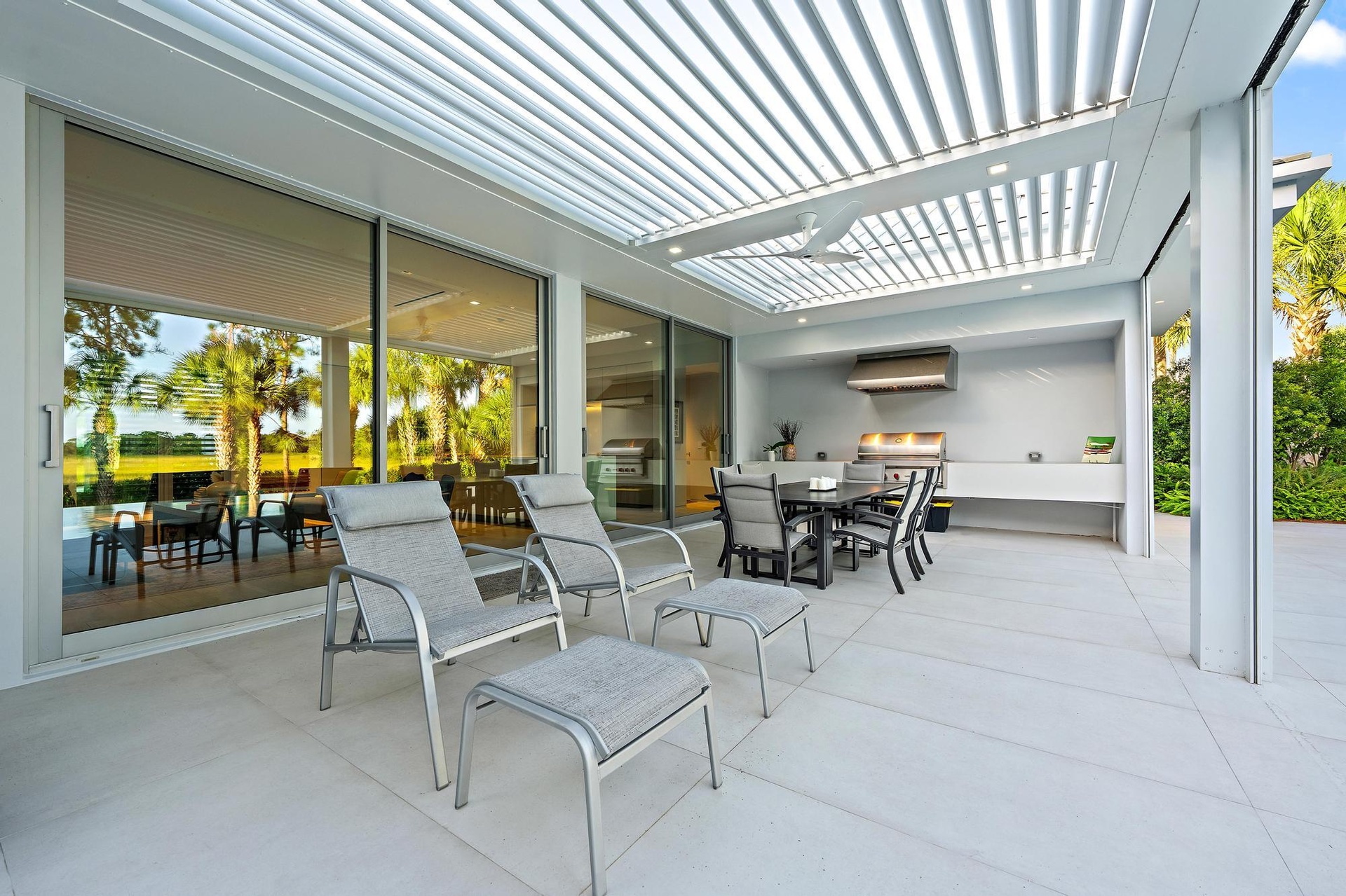 Expansive outdoor living area featuring a louvered patio cover, integrated ceiling fan, and recessed lighting