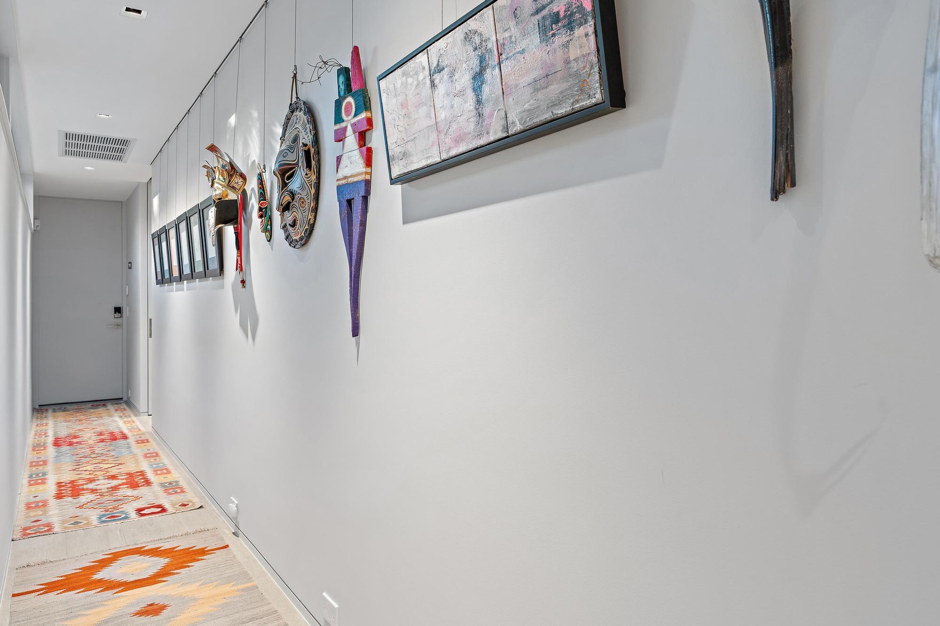 Recessed ceiling lighting, light gray wall finishes, and a light-colored wood-finish floor