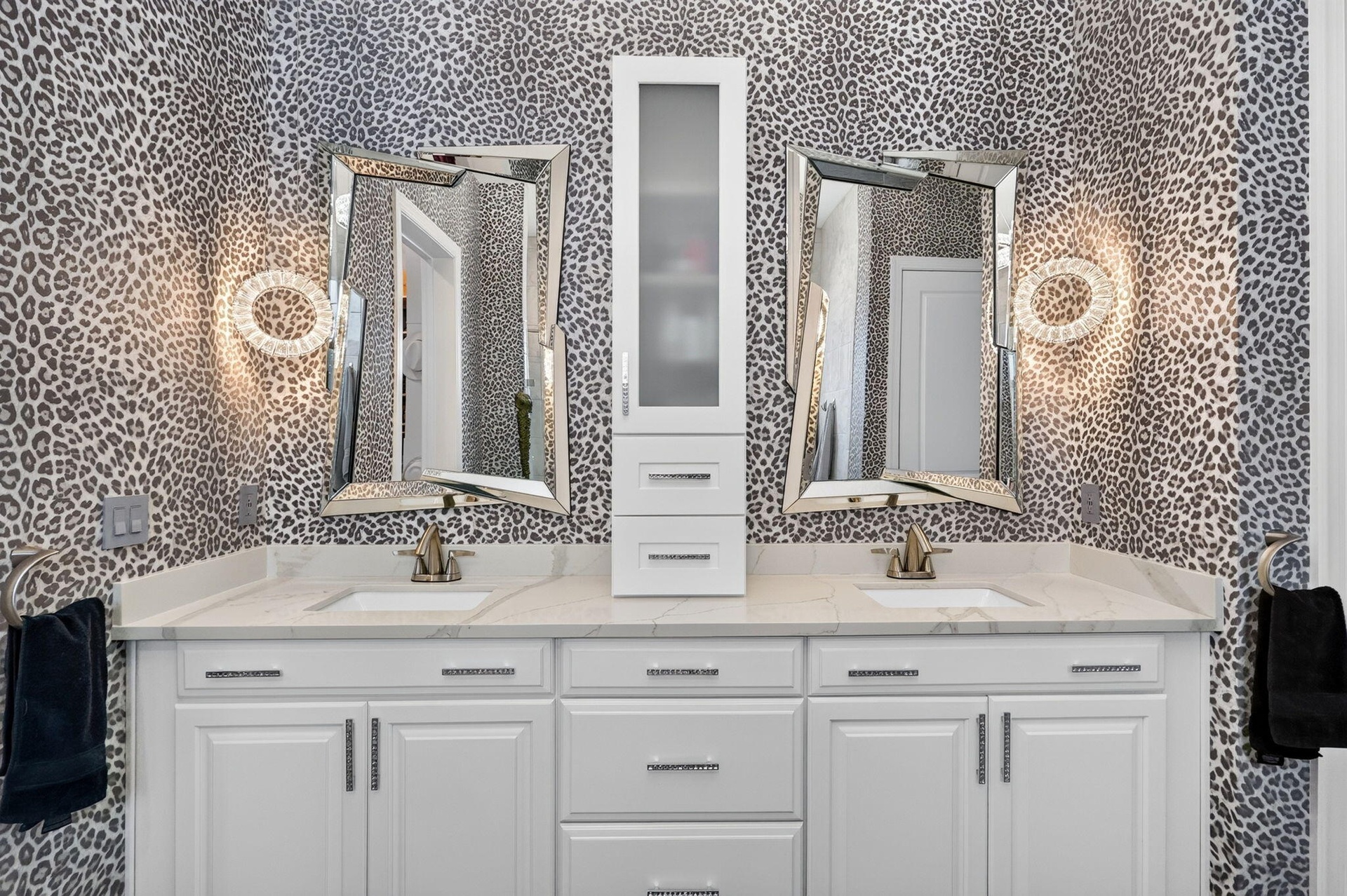Large double vanity with quartz tops with double vanities, custom mirrors, lighting, faucets and Italian wallpaper.