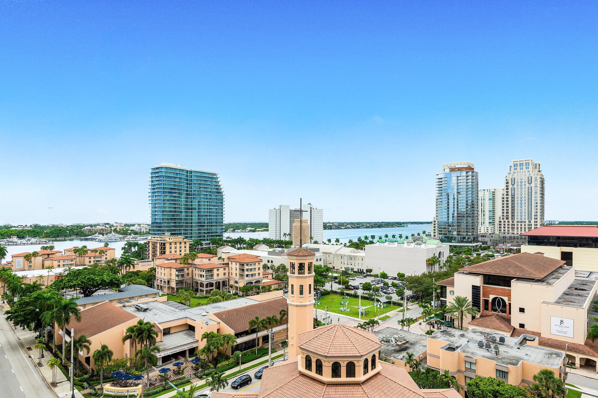 Expansive cityscape with architecturally diverse buildings and the Intracoastal Waterway.