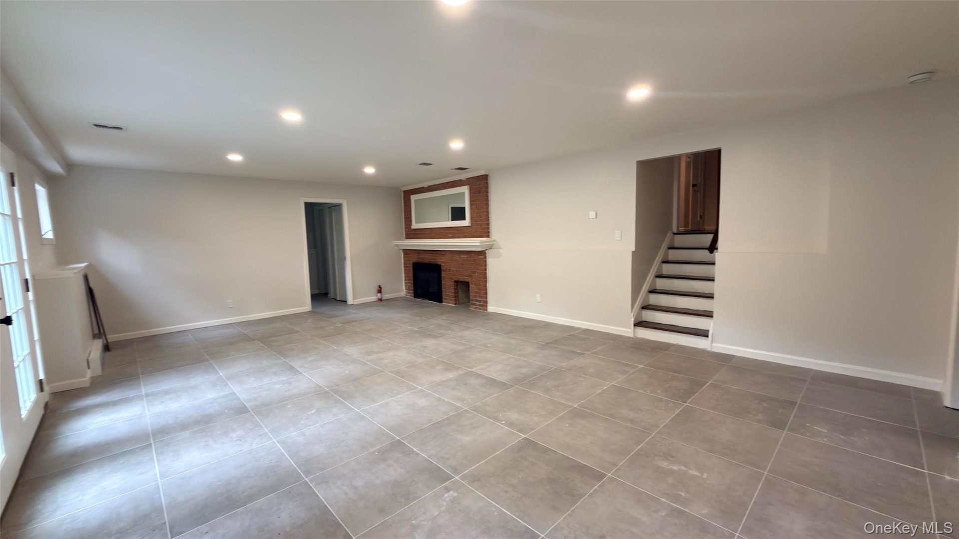 Downstairs Den, brand new floors. On this level, you have the laundry room, 4th bedroom, 1.2 bathroom, direct access to rear yard. (Use of fireplace n