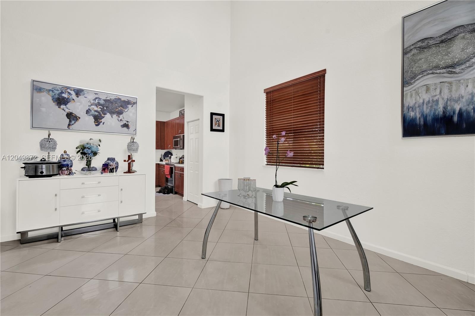 Polished tile flooring, neutral wall finishes, glass-paneled double doors, and ceiling-mounted fans