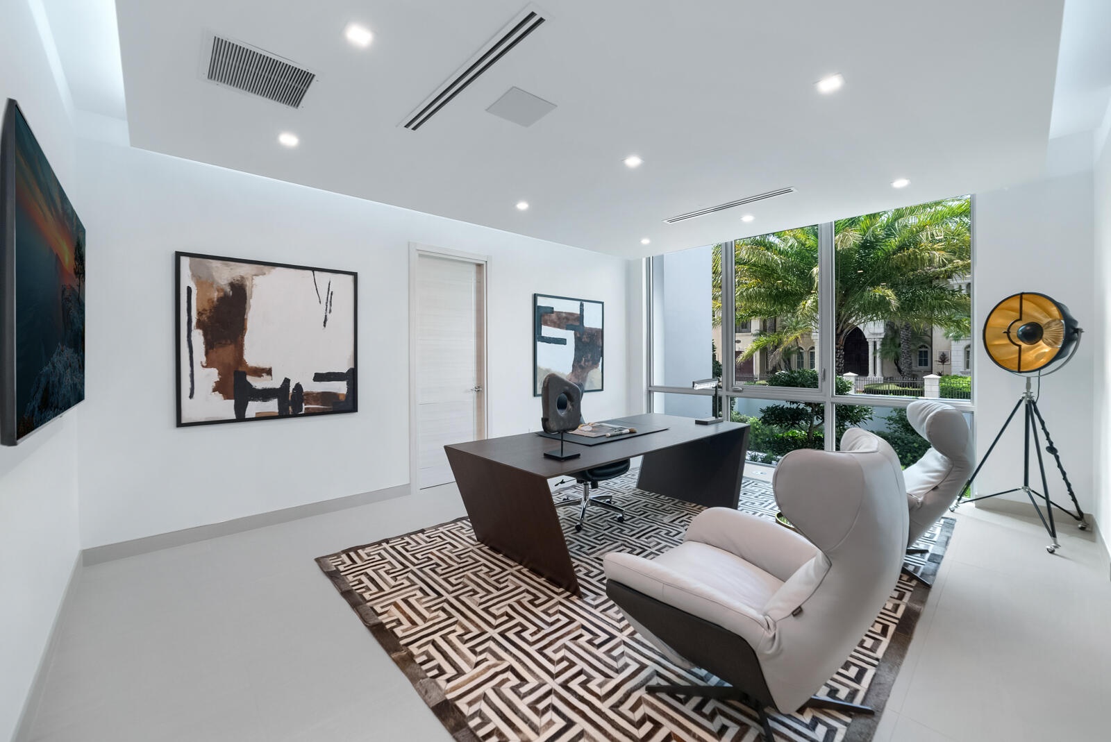 Sophisticated first-floor executive office featuring floor-to-ceiling windows, contemporary designer finishes, abundant natural light, and serene view