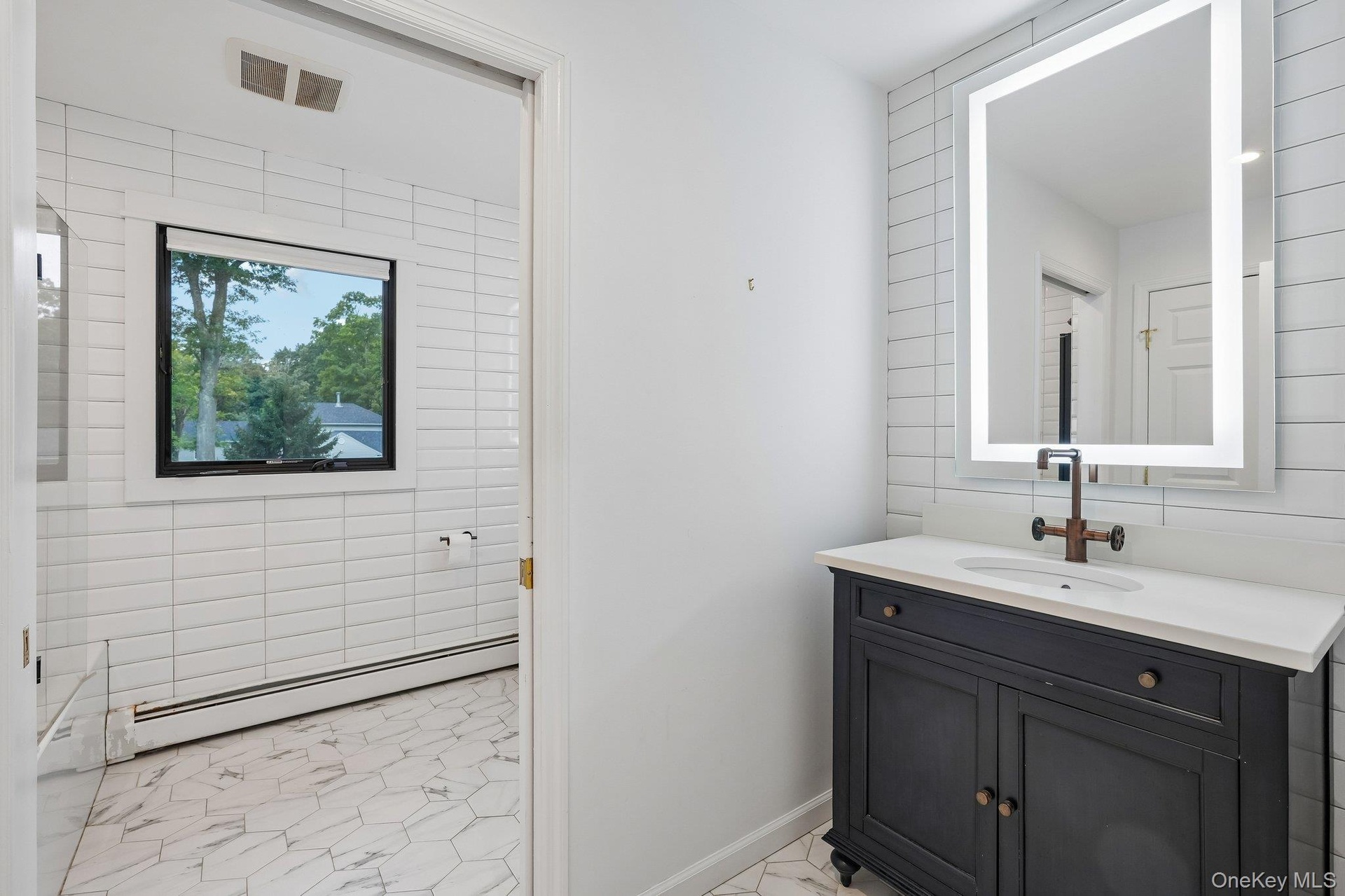 Main bathroom with pocket door partition from toilet & tub