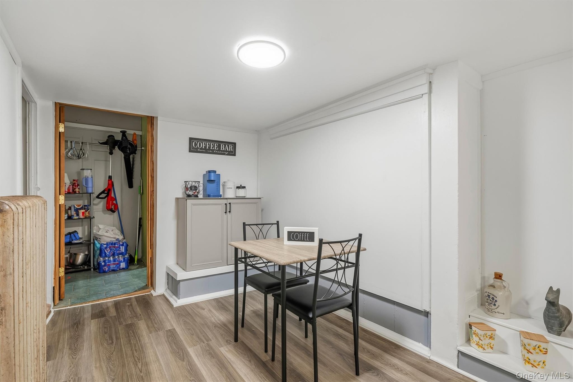 MAIN HOUSE - Laundry and storage area with a washer, dryer, shelving and utility space.