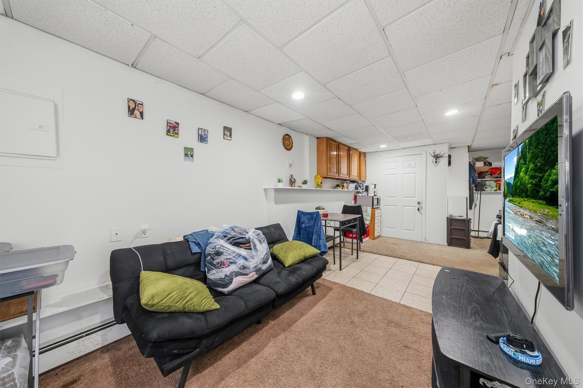 APARTMENT - Living area with an open view into the kitchen and dining space.