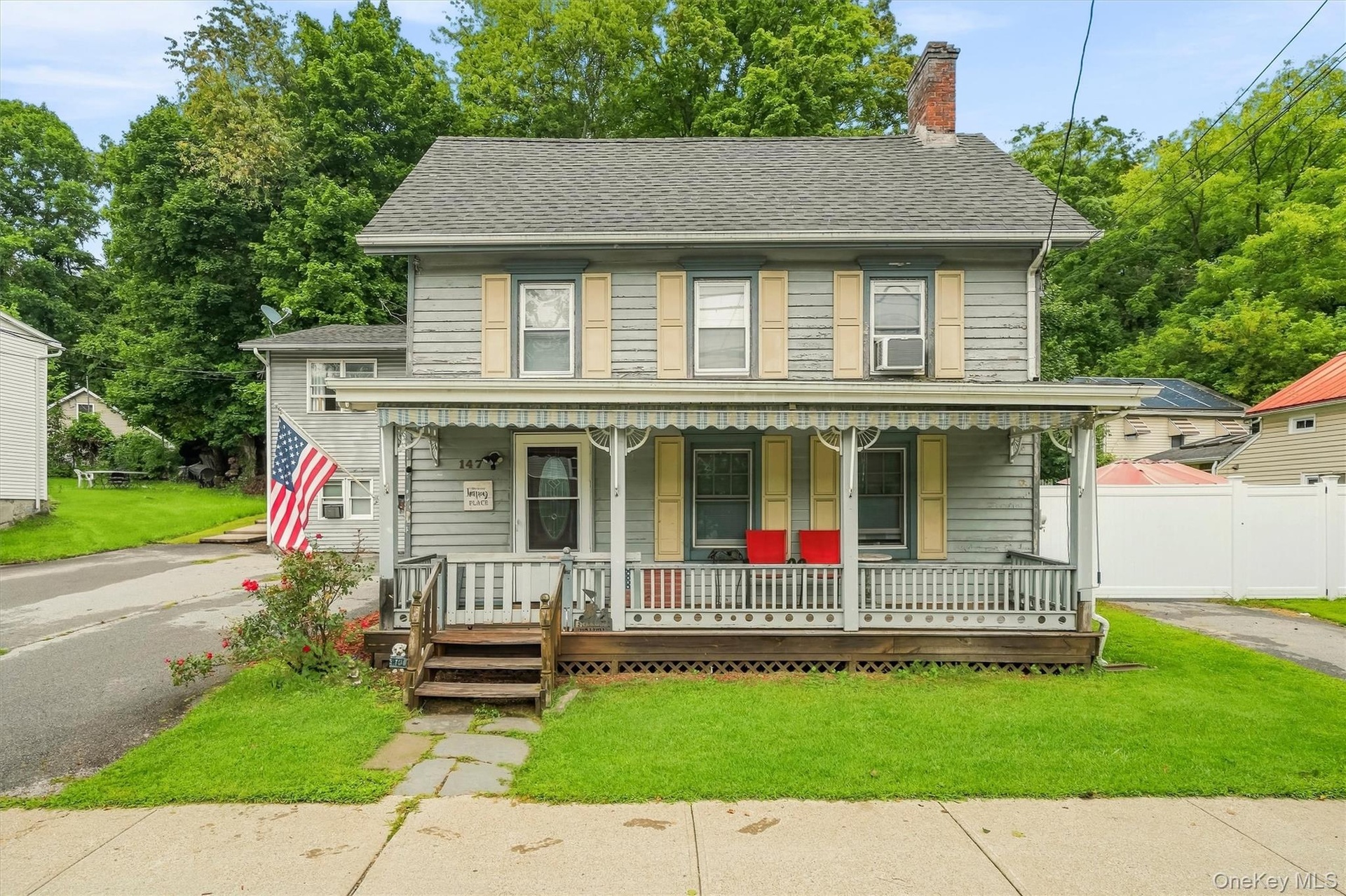 Full front view highlighting the home’s traditional character and expansive covered porch.