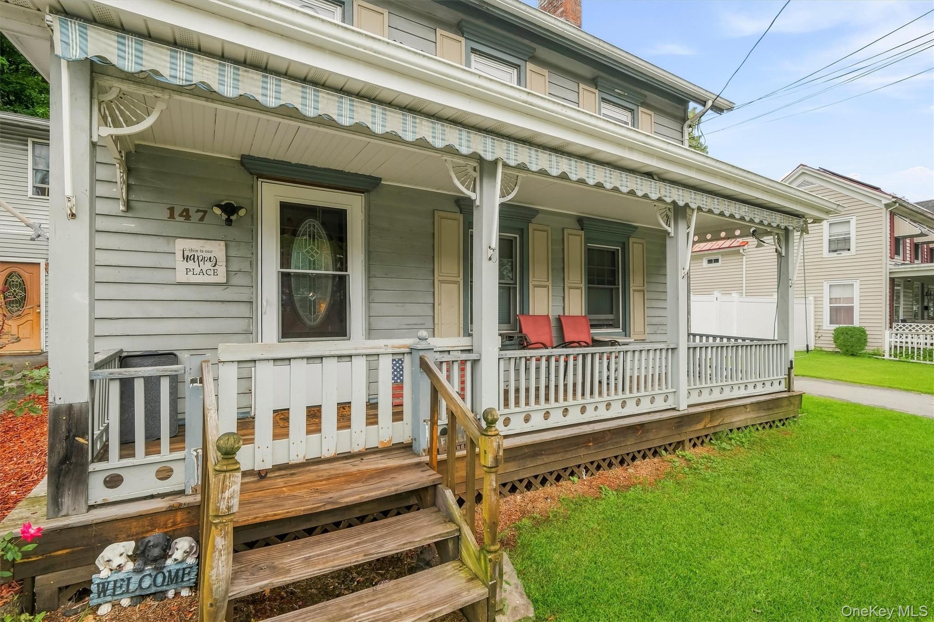 A closer look at the covered front porch; an inviting outdoor space ready for restoration and personal touches.