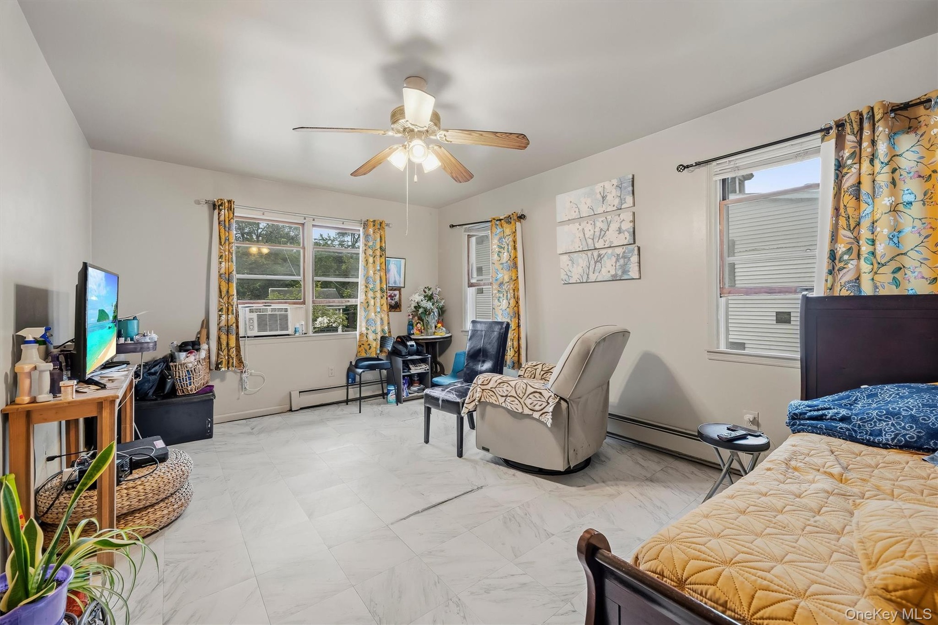 APARTMENT - Spacious bedroom with multiple windows and flexible furniture space.