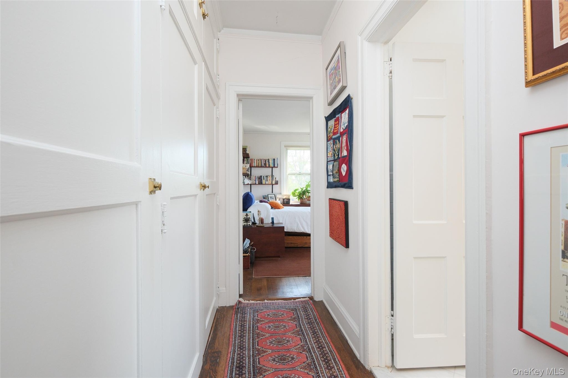 Apt. 4-B  Private Hall | Dressing Area w/ wall of closets (on left), entrance to Primary Bath (on right) and Primary Bedroom beyond.