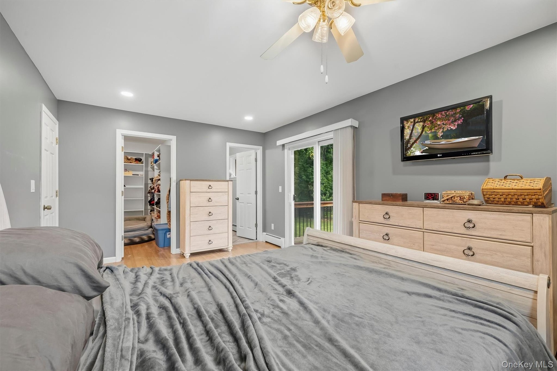 Recessed lighting, wood-finish flooring, walk-in closet, ceiling fan, and sliding glass door