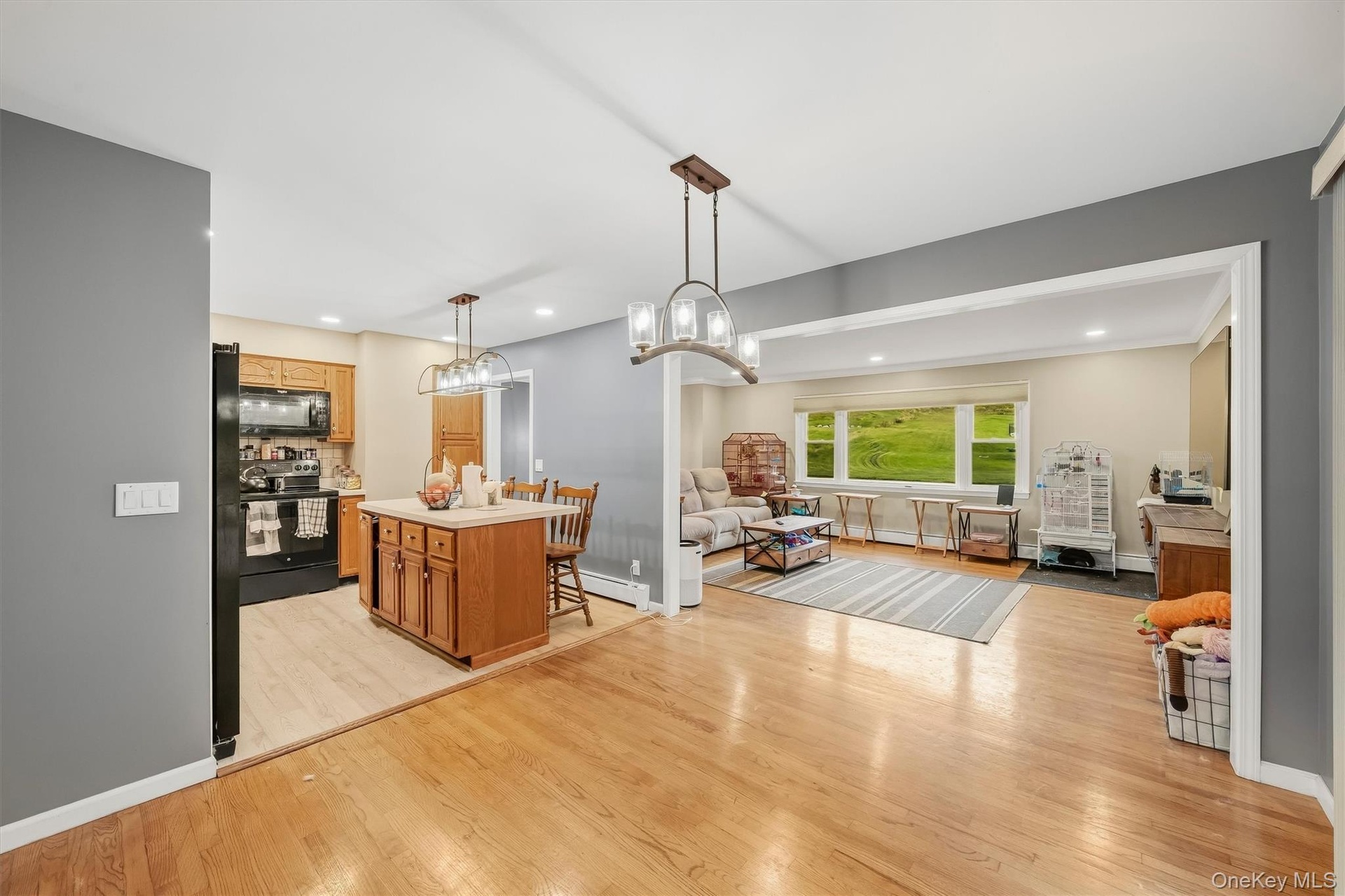 Wood-finish flooring throughout, with a kitchen island featuring wood cabinetry