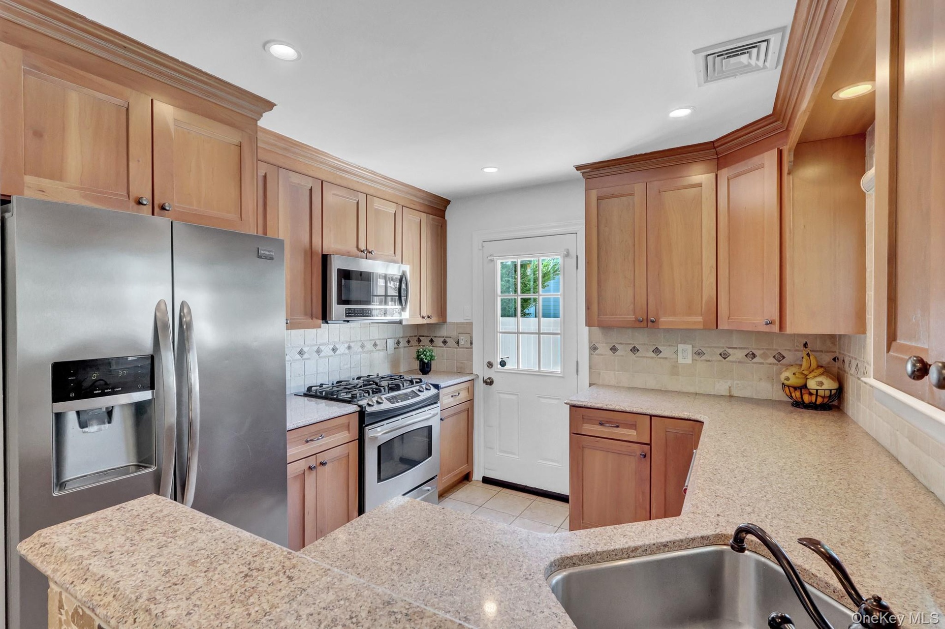 Granite countertops, updated applianced, natural gas cooking, outside separate entrance leads to side/rear fenced yard.