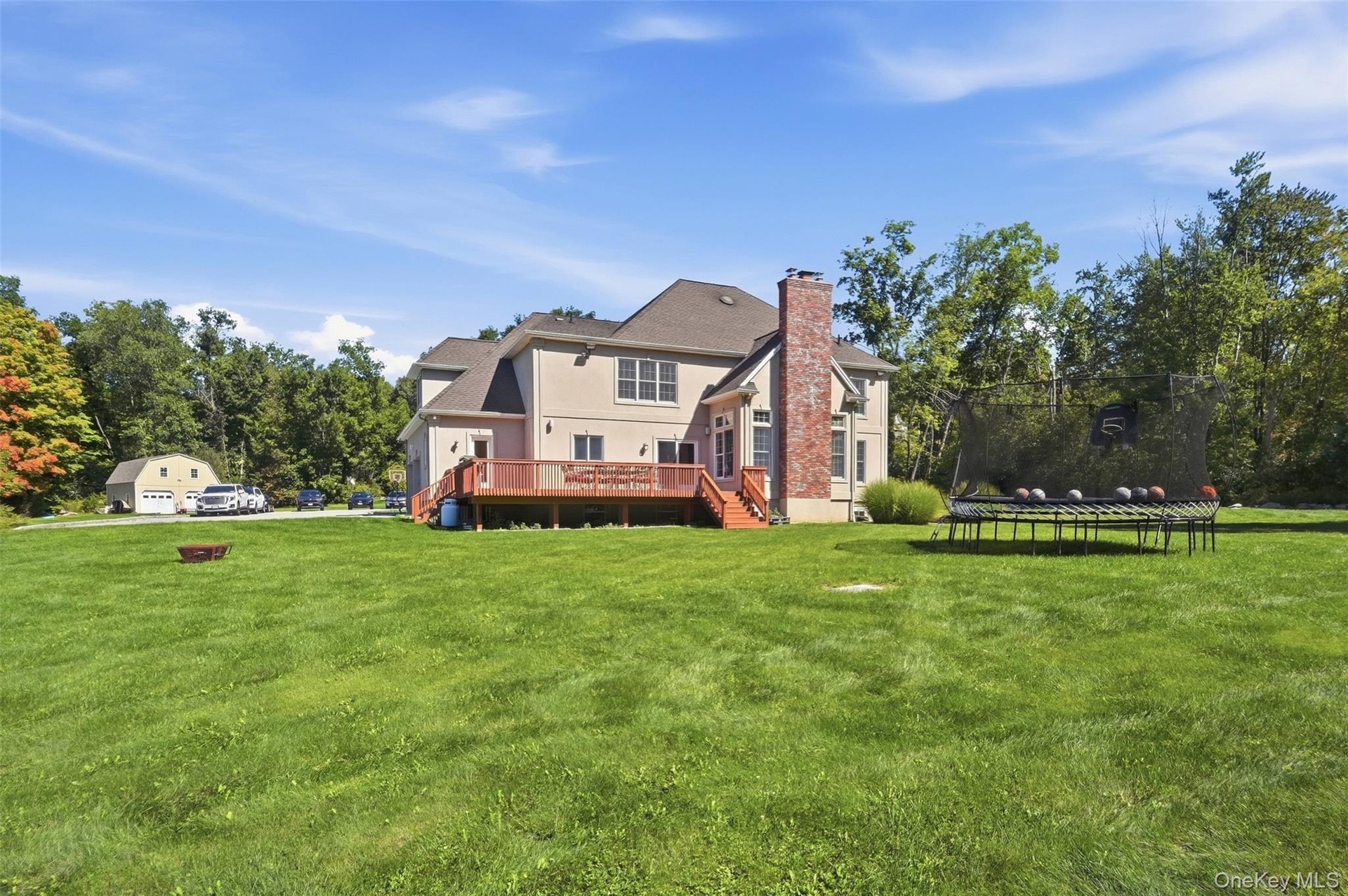 Back of house with view of 2-story garage