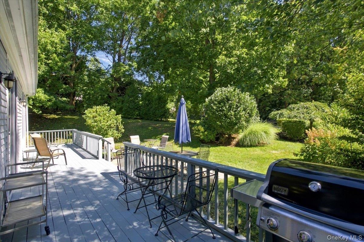 The new deck complemented by a beautiful bluestone patio, is easily accessed through sliding glass doors from both the kitchen and dining area creatin