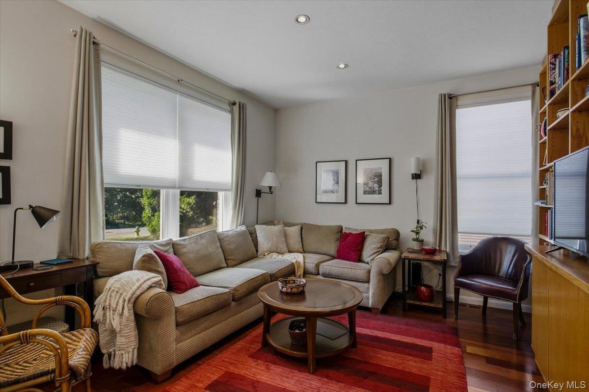 The den features custom built-ins and new double hung windows overlooking both the front and side of the home filling the room with natural light.