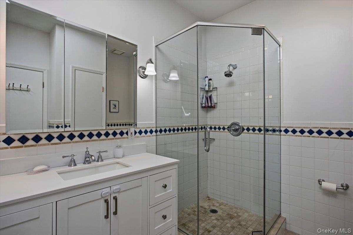 The primary bathroom features a standalone shower and double vanity.