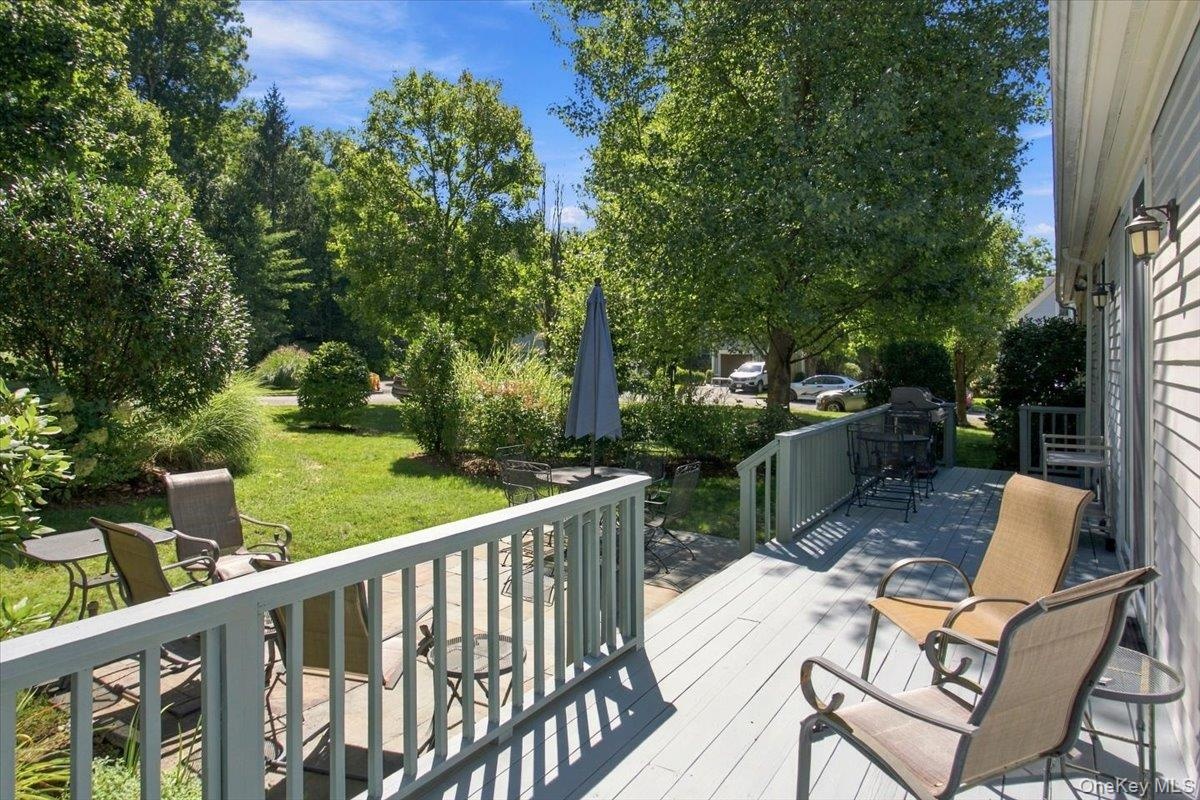 Another view of the deck showcases the landscaped yard and exceptional privacy.