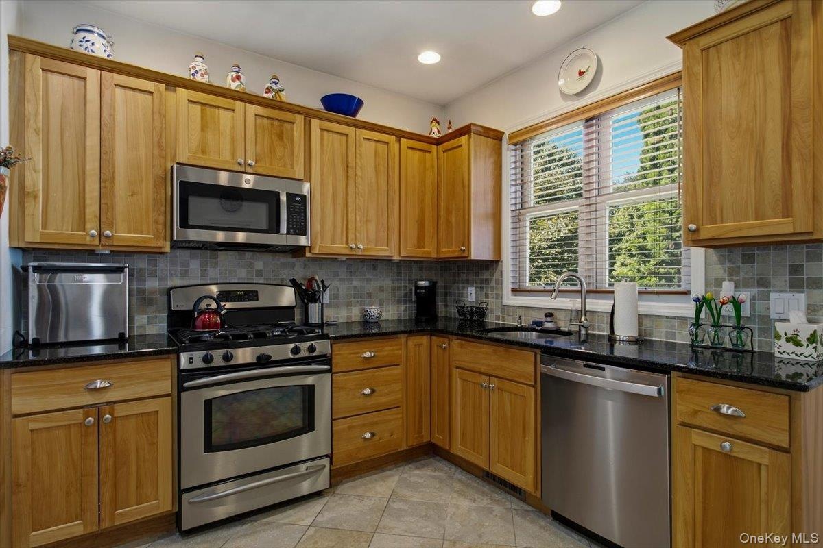 The kitchen features stainless steel appliances, granite countertops and durable ceramic-tile flooring.
