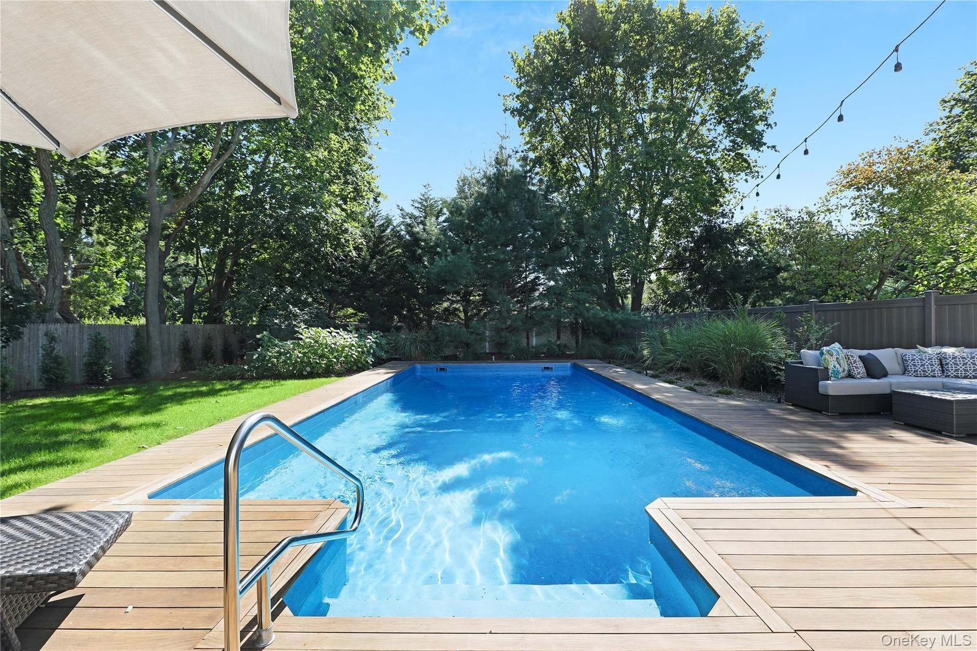 View of pool with a fenced backyard, an outdoor hangout area, and a patio area