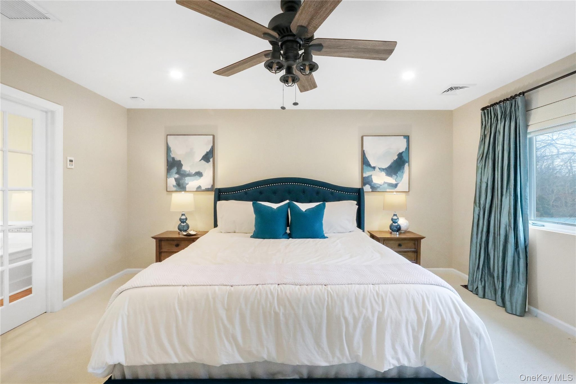 Carpeted bedroom featuring a ceiling fan and recessed lighting