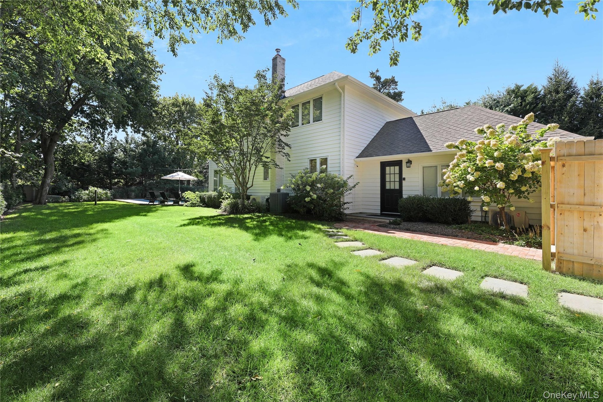 View of front of property featuring roof with shingles and a chimney