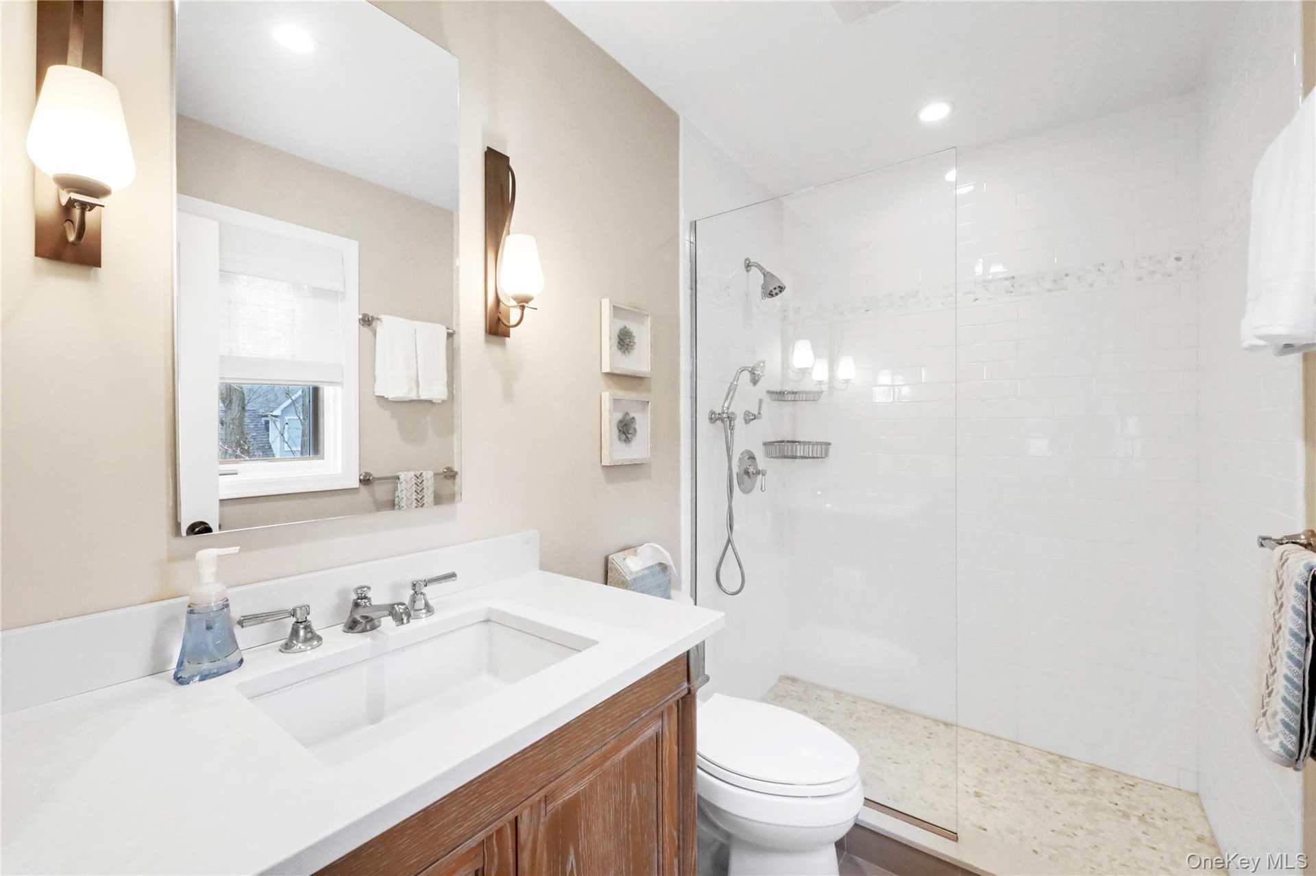 Bathroom featuring vanity, walk in shower, and recessed lighting