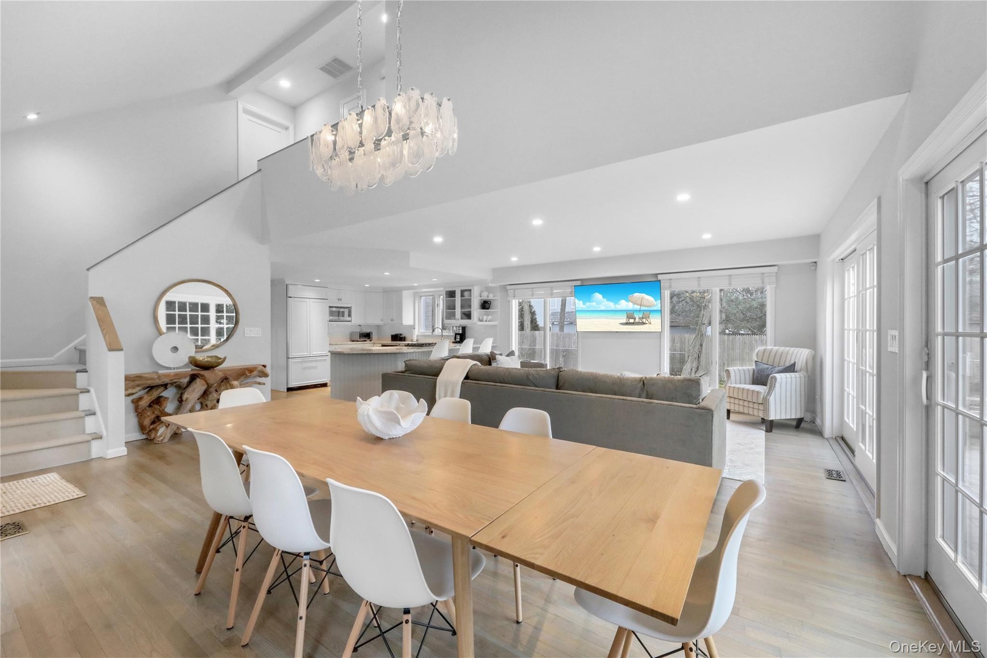 Dining area with stairway, light wood-type flooring, recessed lighting, and a towering ceiling