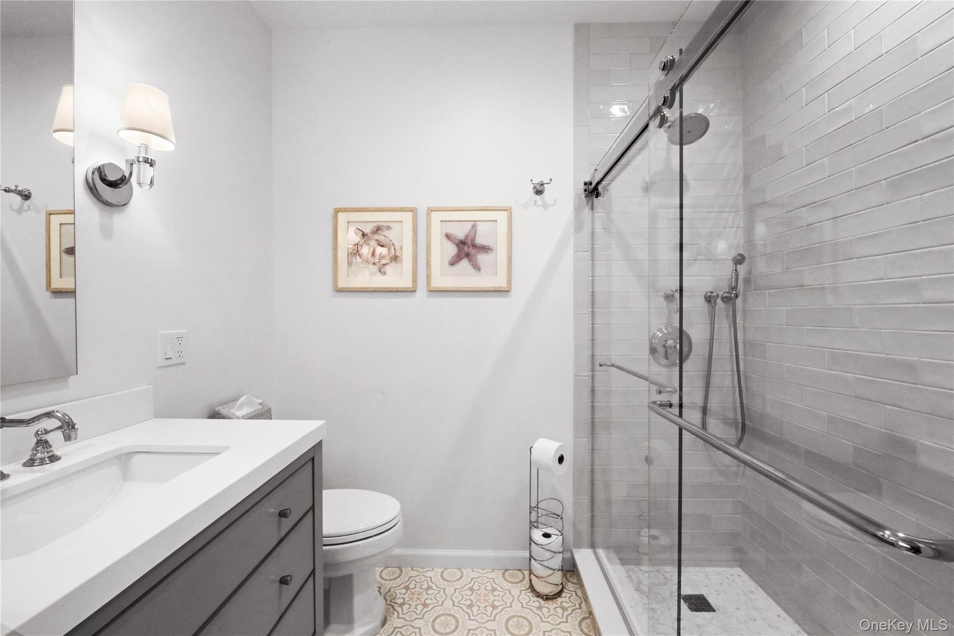 Bathroom featuring vanity, a shower stall, and light tile patterned flooring