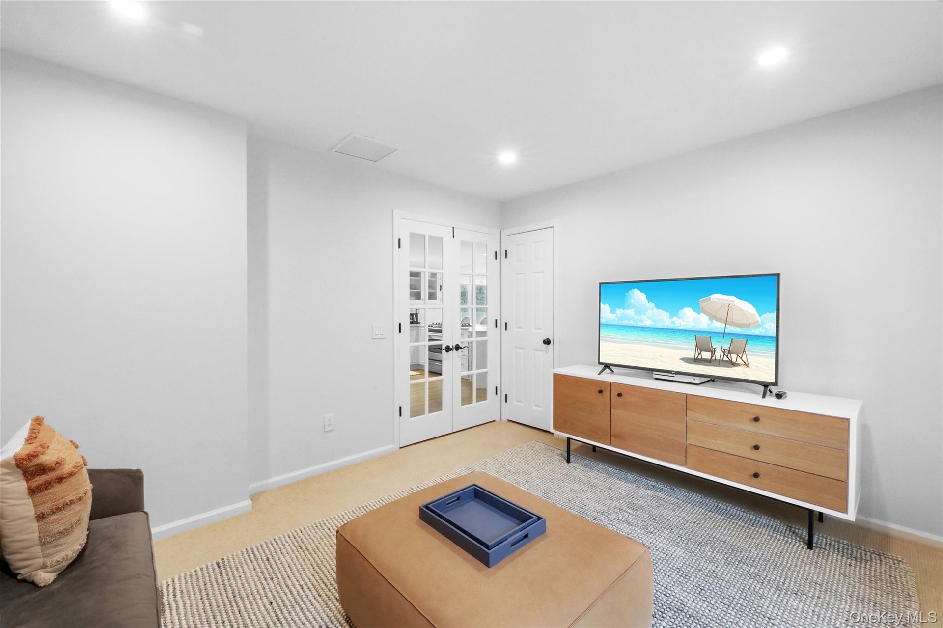 Living room with french doors, recessed lighting, and light carpet