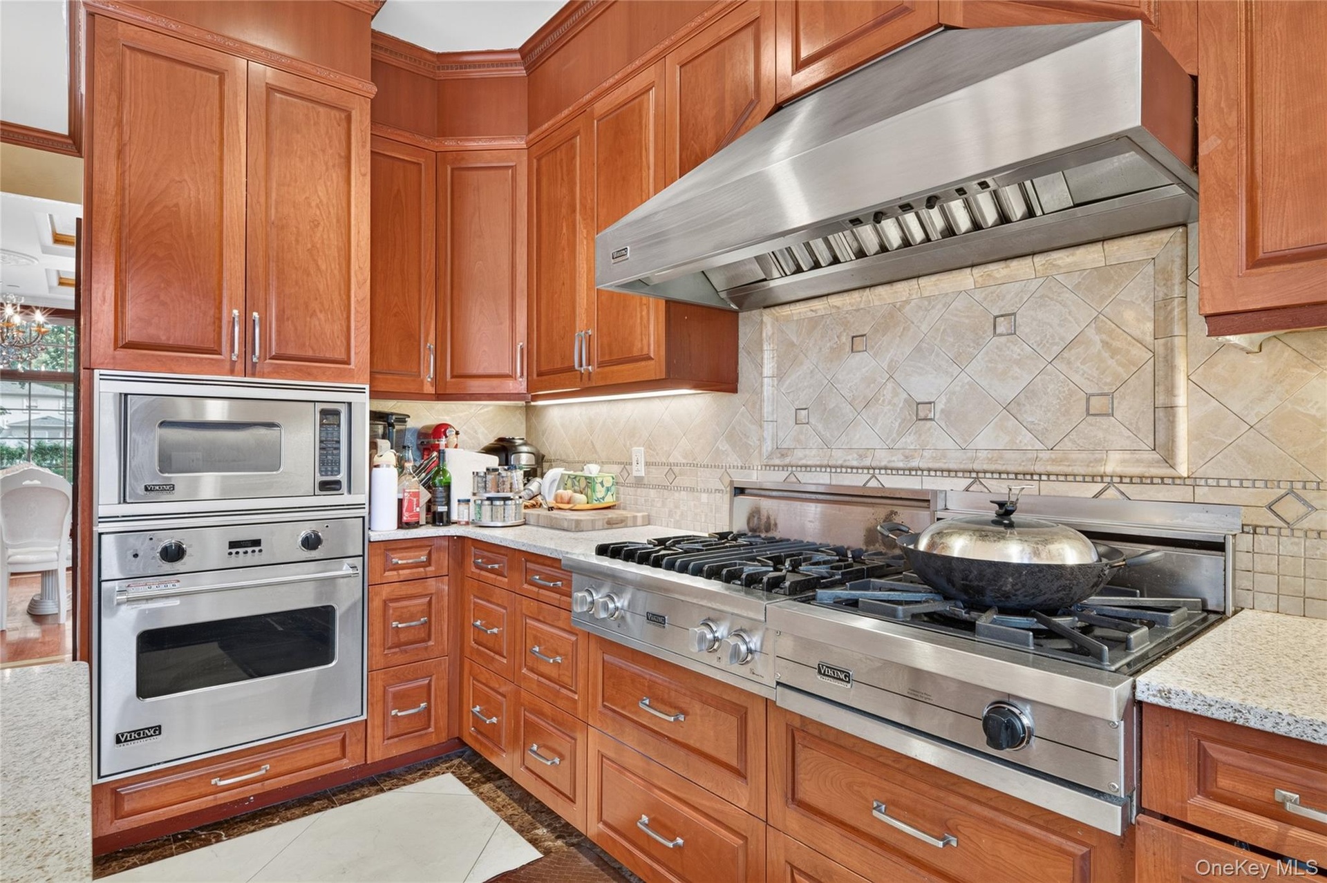Cherry wood cabinetry complemented by granite countertops