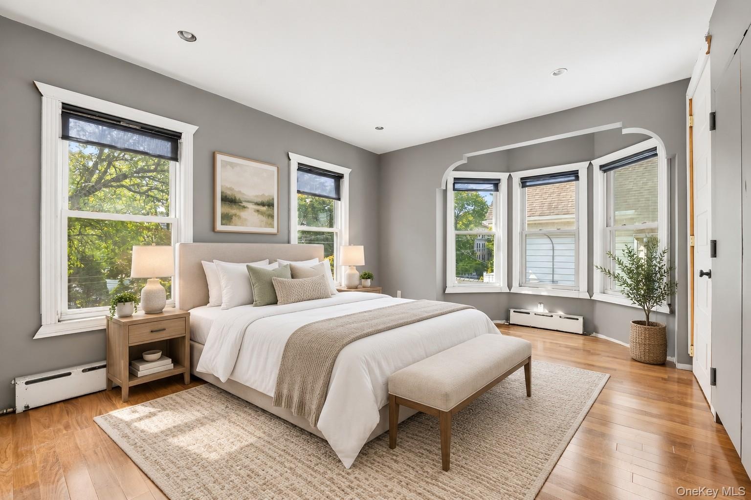 **Virtually Staged** Hardwood flooring, recessed lighting, and a multi-window bay feature