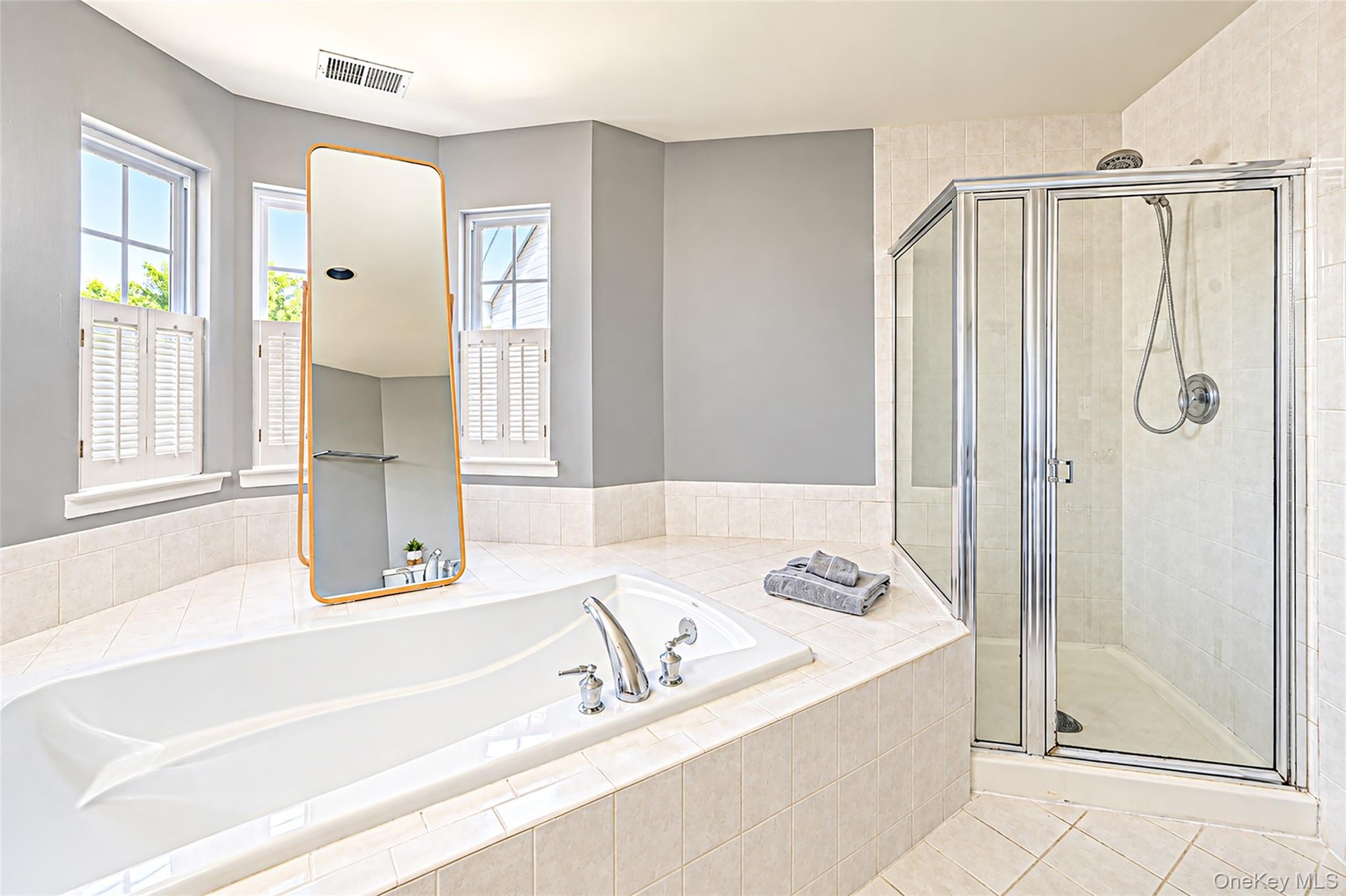 Alternate view of sun filled primary bathroom